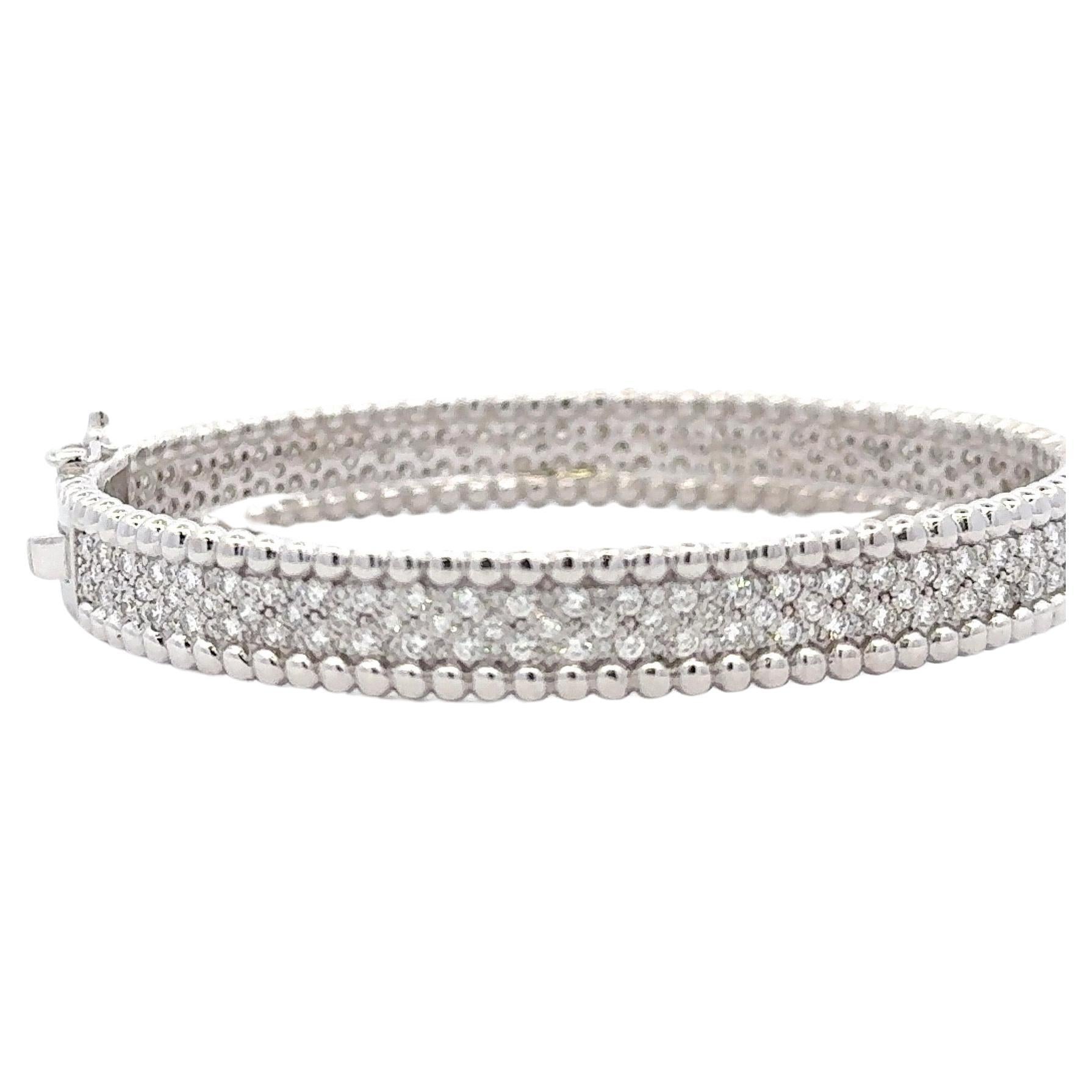14 Karat white gold bangle bracelet featuring three rows of 286 round brilliants weighing 3.88 carats.
Sparkles & full of life.
Can be made in yellow or rose gold.

Color F-G
Clarity VS1-VS2