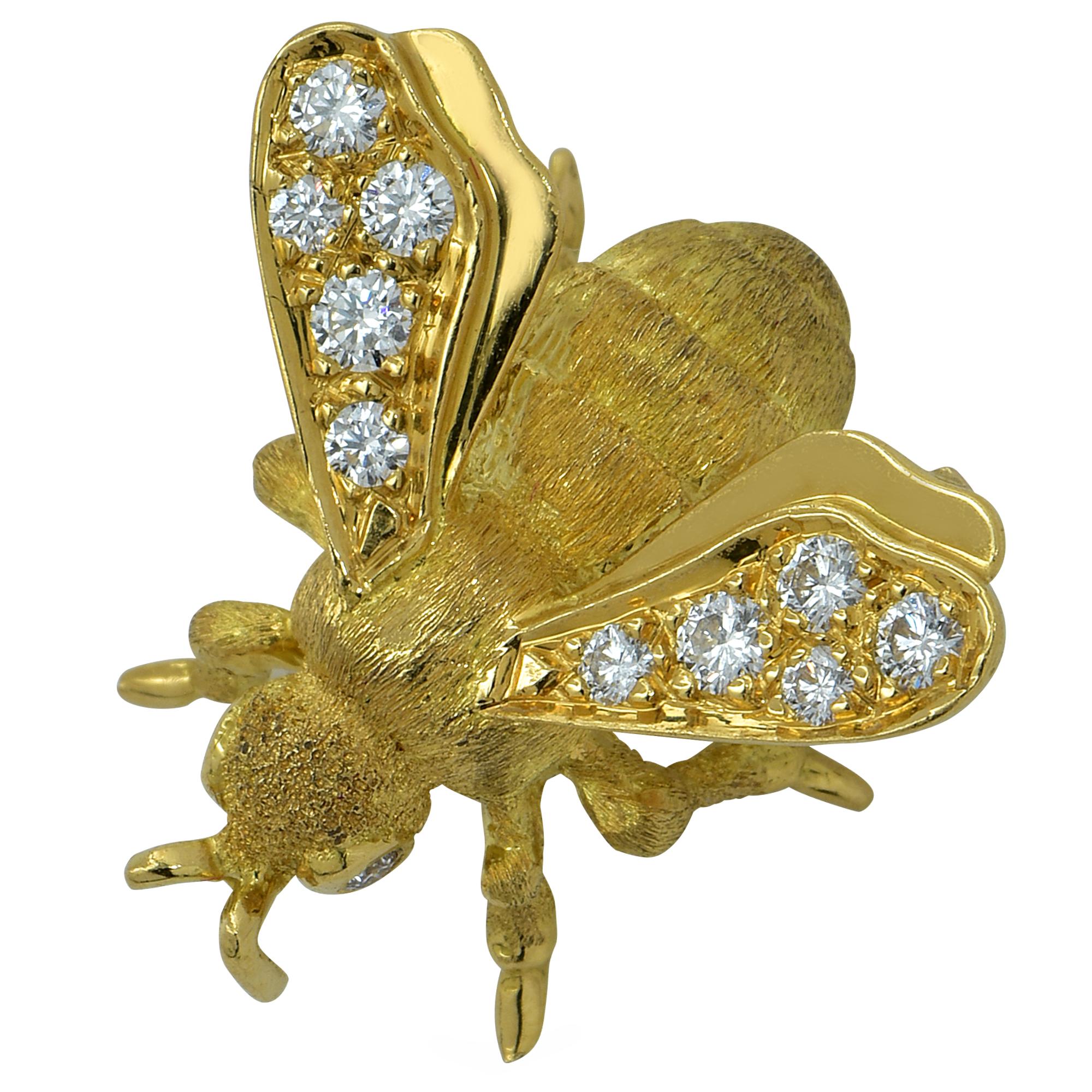 Enchanting Bee brooch pin crafted in 18k Yellow Gold, showcasing 2 round brilliant cut diamond eyes, and wings adorned with 10 round brilliant cut diamonds. The diamond weight is approximately .40cts total G color VS clarity. This beautiful brooch