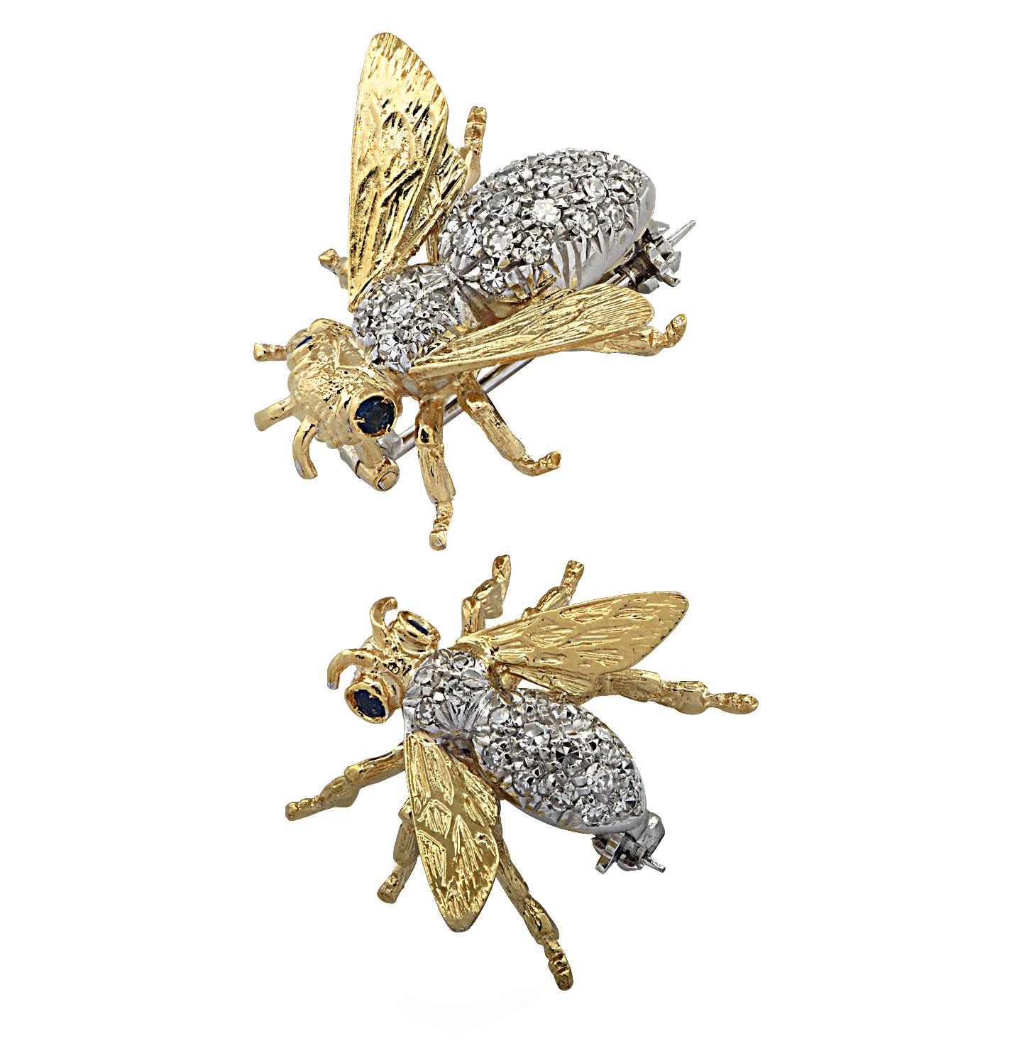 Enchanting Bee Brooch Pin set featuring two bees intricately crafted in 18 karat yellow and white gold with bodies encrusted with 34 single cut diamonds weighing approximately .75 carats total G color VS clarity, textured wings and blue sapphire