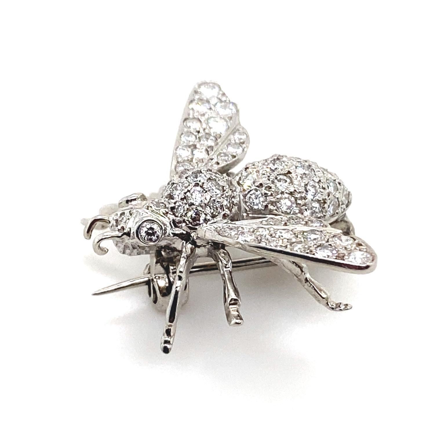 A diamond bee brooch pin set in 18 karat white gold.

This sweet and realistically detailed brooch is set to its head with two pinkish tinted round brilliant cut diamond for eyes. The thorax, abdomen and wings of the bee comprise of intricately
