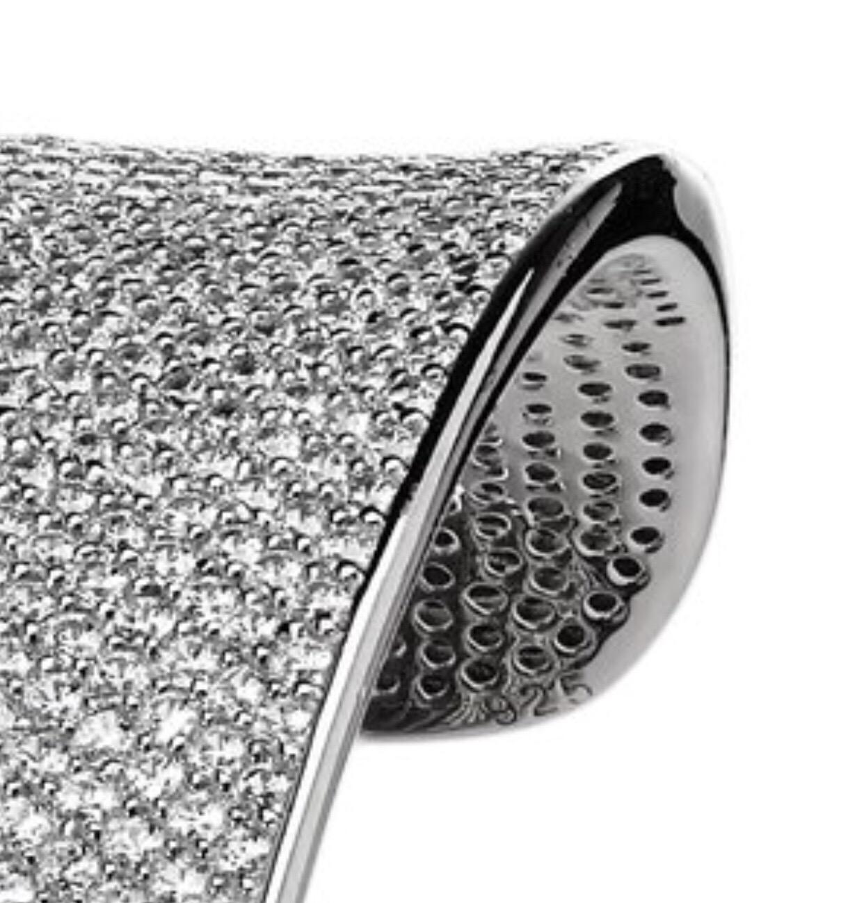 This spectacular micro-set cuff bangle is a guaranteed show stopper. Encrusted with over 2,500 of white round brilliant cut diamonds, this statement bangle has been handcrafted to the highest possible standard. Featuring 47.78 carat of white