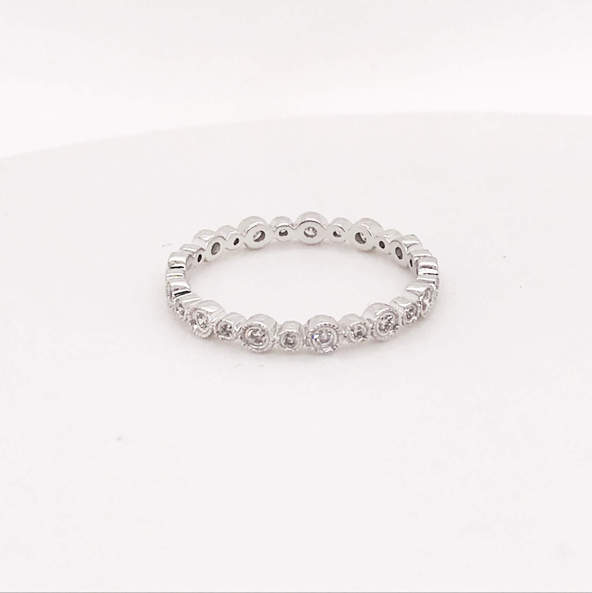 Diamond bubble band with round brilliant diamonds! This band is 14k white gold with bright white diamonds set in two different bezel sizes for an alternating bubble design. The diamond band design resembles champagne bubbles changing in size and