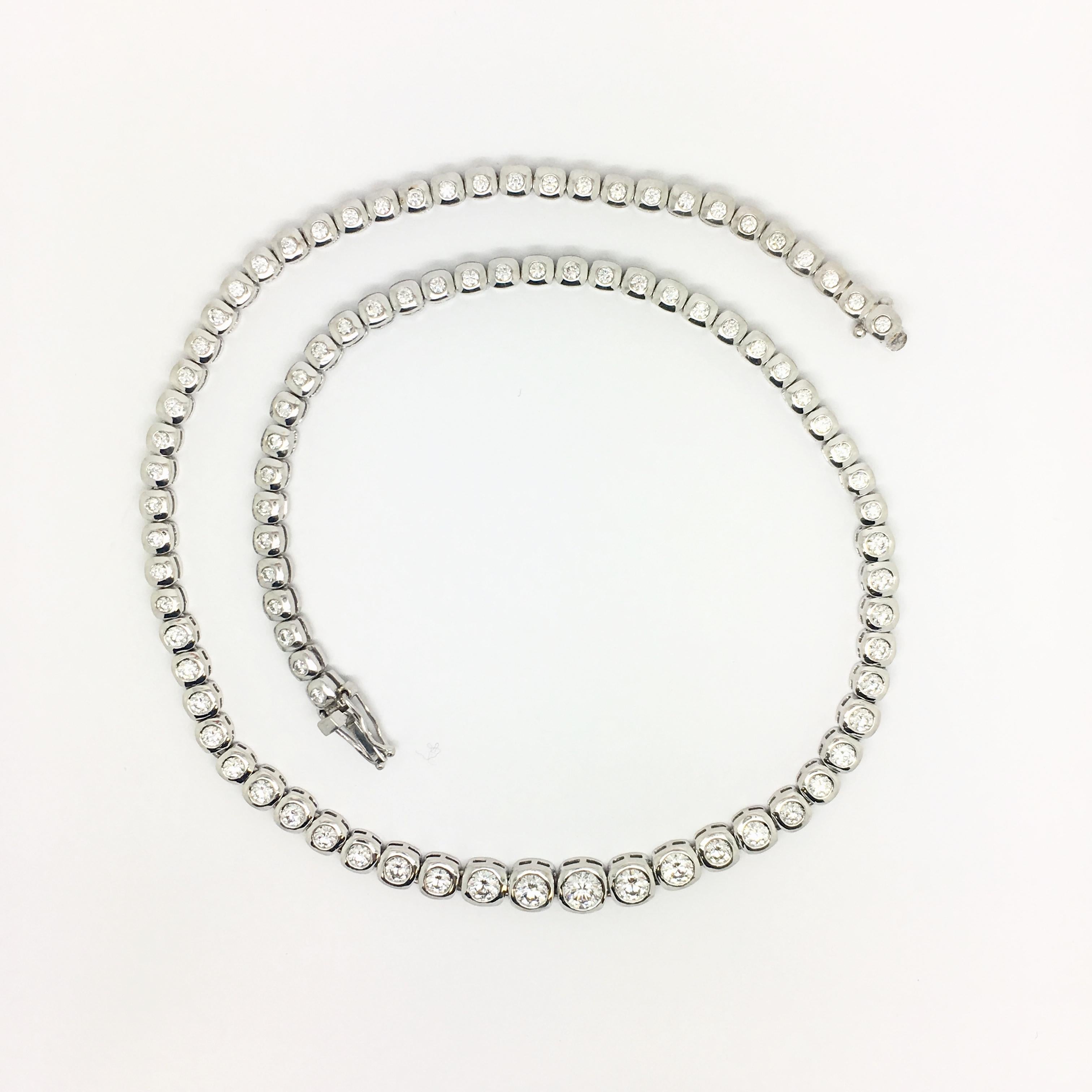 This diamond bezel set necklace made in 18kt white gold features approximately 6.07 total carat weight of diamonds.  There are 91 round brilliant diamonds, SI2 clarity ranging in colour from F-G. This piece is 17 inches in length, sitting