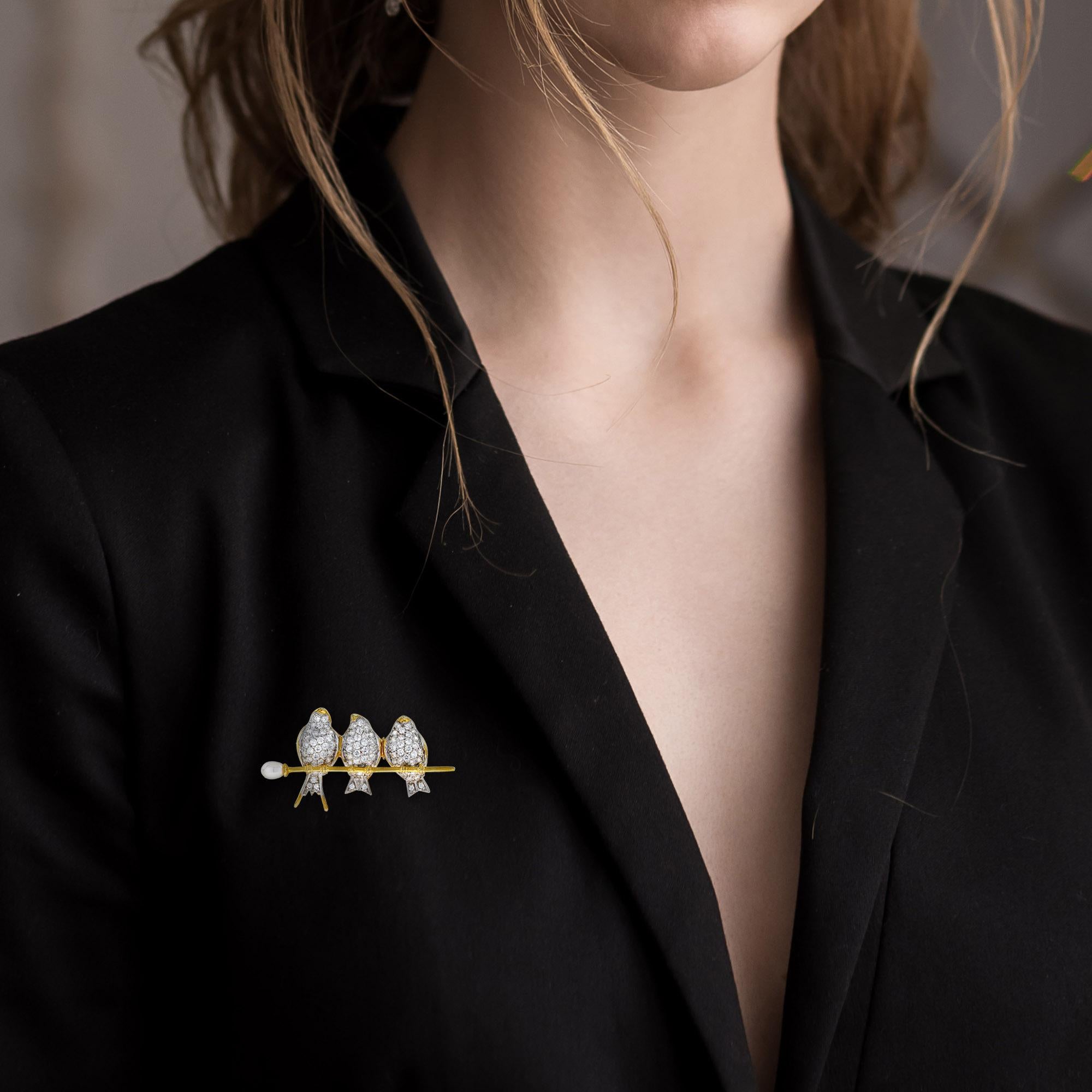 Three little singing birds sitting on a branch. Each bird has been studded with sparkling diamonds. The novelty birds brooch is therefore used in many cases to signify love and constancy across both distance and time. The branch is set with natural
