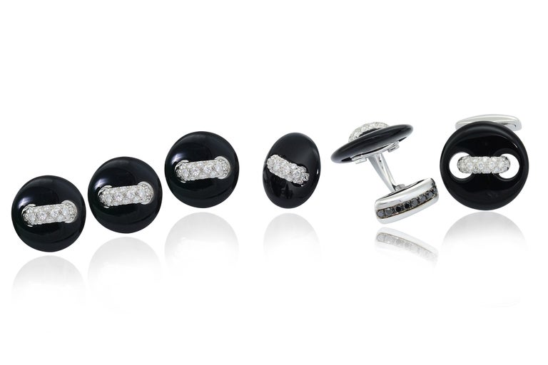 Original, unique and precious, the cufflinks are handcrafted in onyx, 18Kt white gold,  diamond pavé set and a line of black diamonds on the T bar.  It is a unisex piece of jewelry.

18KT white gold grams 10.80
n. 38 white diamond ct 0.72 quality of
