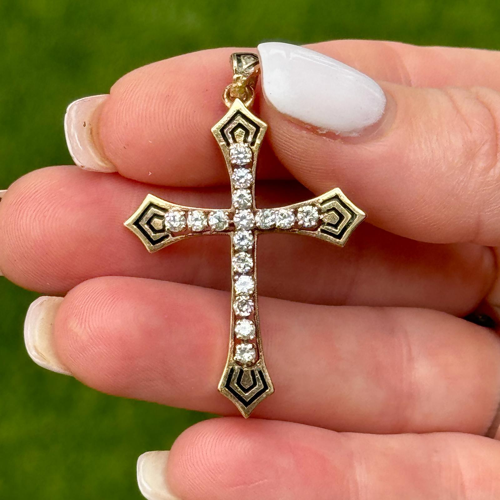 This vintage 14-karat yellow gold cross pendant exudes timeless elegance with its striking combination of diamonds and black enamel. The cross is adorned with 16 round brilliant-cut diamonds, totaling 0.75 carats, graded H-I in color and SI in
