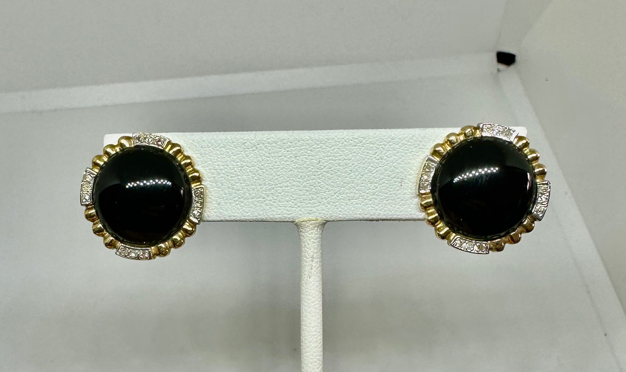 Indulge in classic Diamond and Black Onyx Earrings in 14 Karat White and Yellow Gold.
These beautiful earrings combine stunning white diamonds with round black onyx cabochons in a dramatic design in 14 Karat White and Yellow Gold.  The earrings