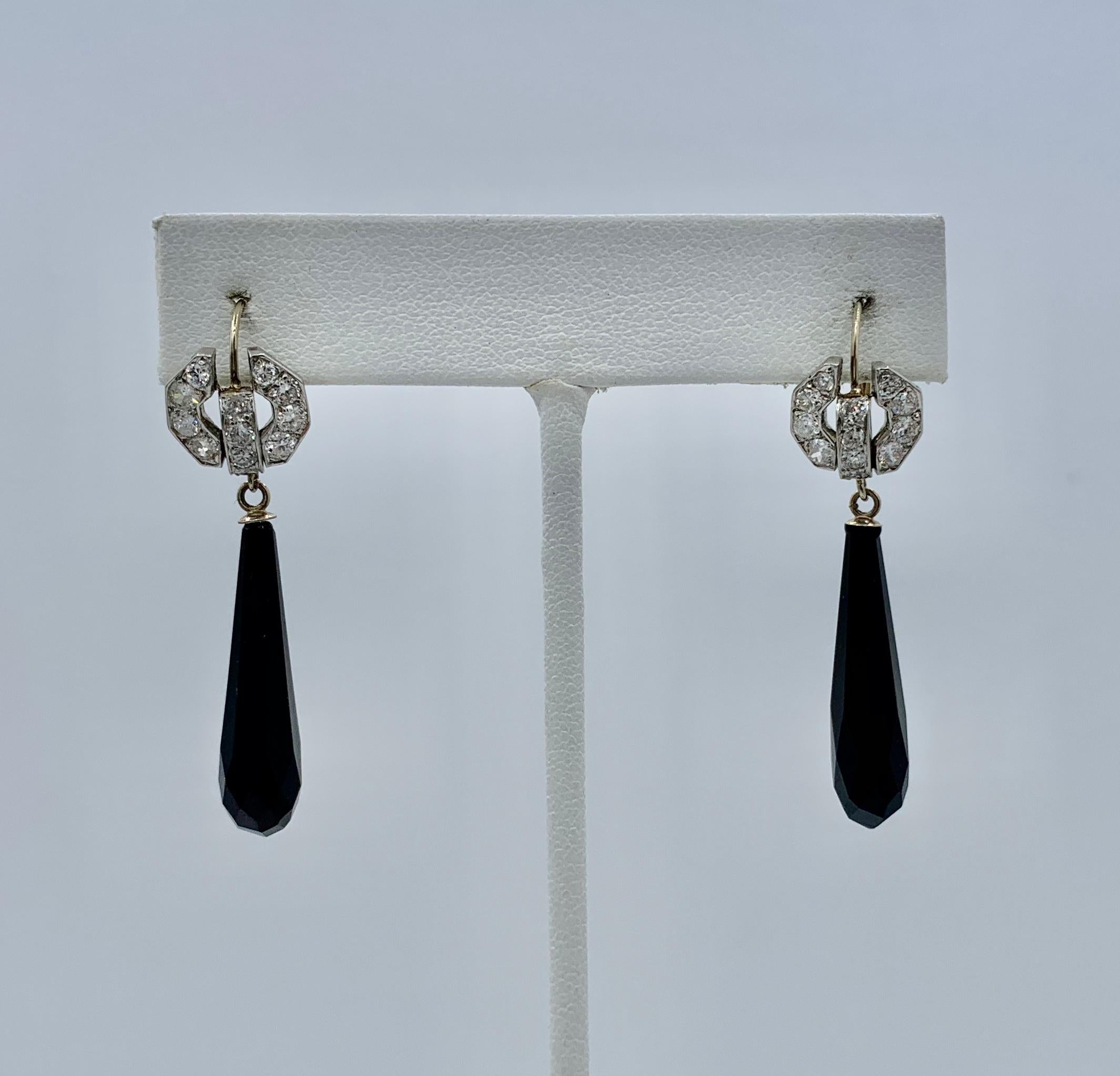 Diamond and Black Onyx Platinum and 14 Karat White Gold Dangle Earrings
These beautiful dangle drop earrings combine 1.2 Carats of stunning white diamonds with faceted black onyx drops in a dramatic design in Platinum atop 14 Karat White Gold.  The