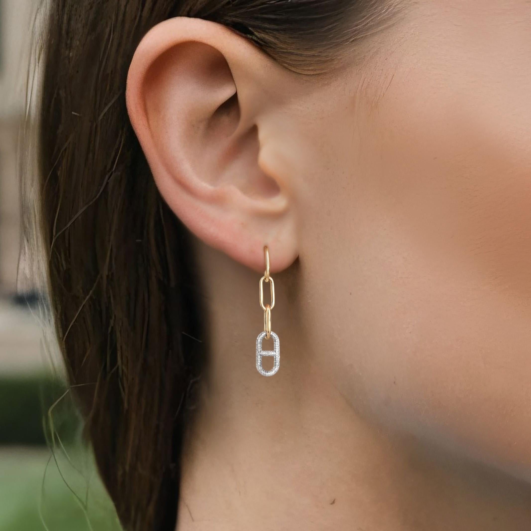 The Diamond Bliss 14K Yellow Gold Drop Earrings showcase the timeless beauty of natural diamonds, set in 14K yellow gold. The graceful drop design allows the diamonds to sparkle with every movement, creating an air of sophistication and luxury.