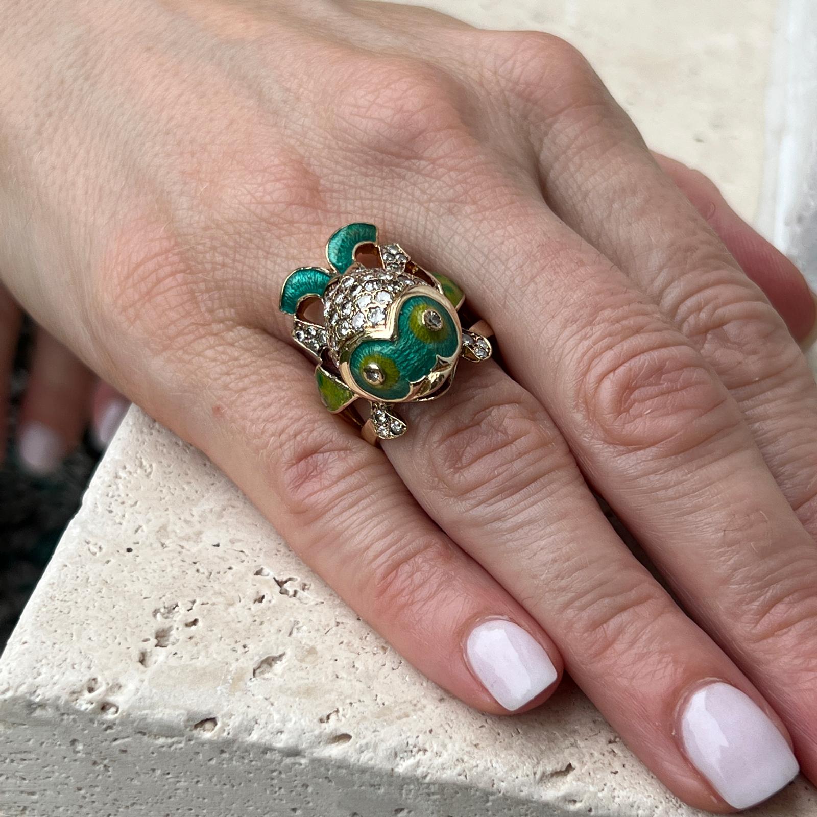 Adorable enamel and diamond fish ring handcrafted in 14 karat yellow gold. The ring features colorful blue and green enamel and round brilliant cut diamonds weighing approximately 1.50 CTW. The diamonds are graded H-I color and SI clarity. The ring
