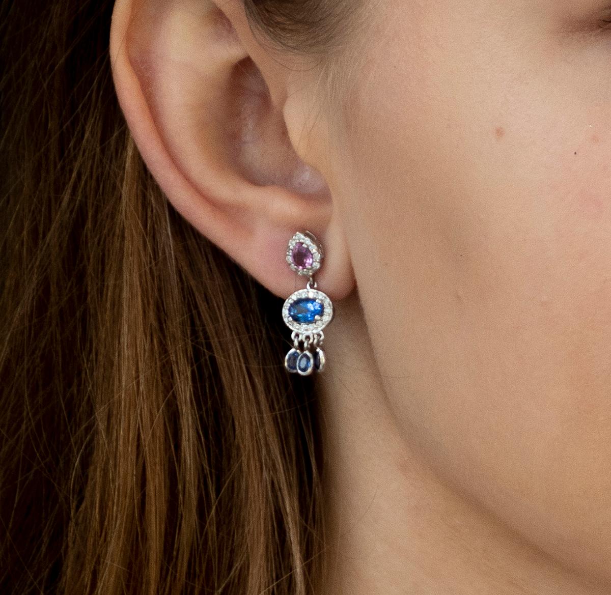 18k white halo diamond and sapphire gold drop earrings One Inch Length 
Pear shape pink sapphire alternating with oval shape blue sapphire in diamond with six Dangle oval sapphires 
Total carat weight of Sapphires 2.85 carats
Diamond weight 0.85