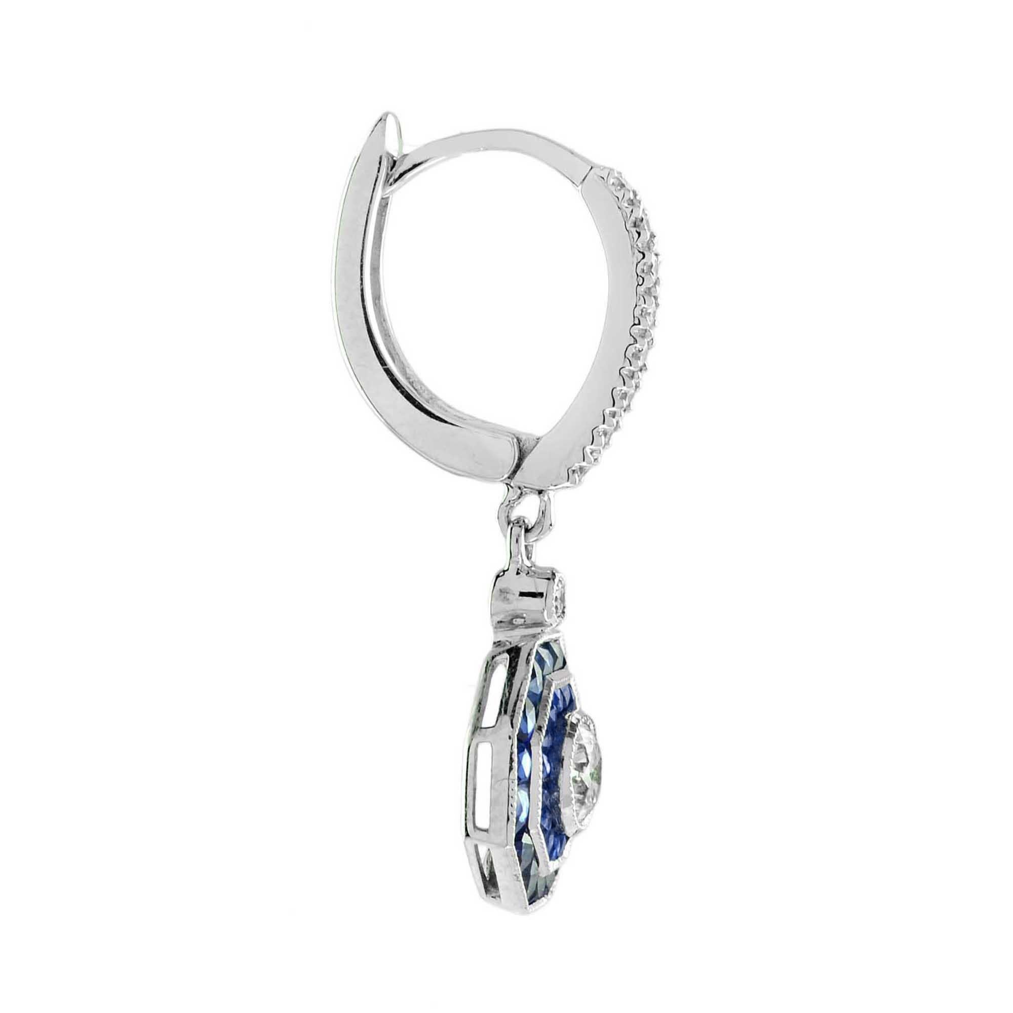 Exquisitos pendientes de diamantes y zafiro azul de inspiración Art Déco. El Diamante central está rodeado de zafiros de doble halo finamente engastados en un exterior que crea una elegante forma octogonal. Los pendientes se llevan perfectamente con