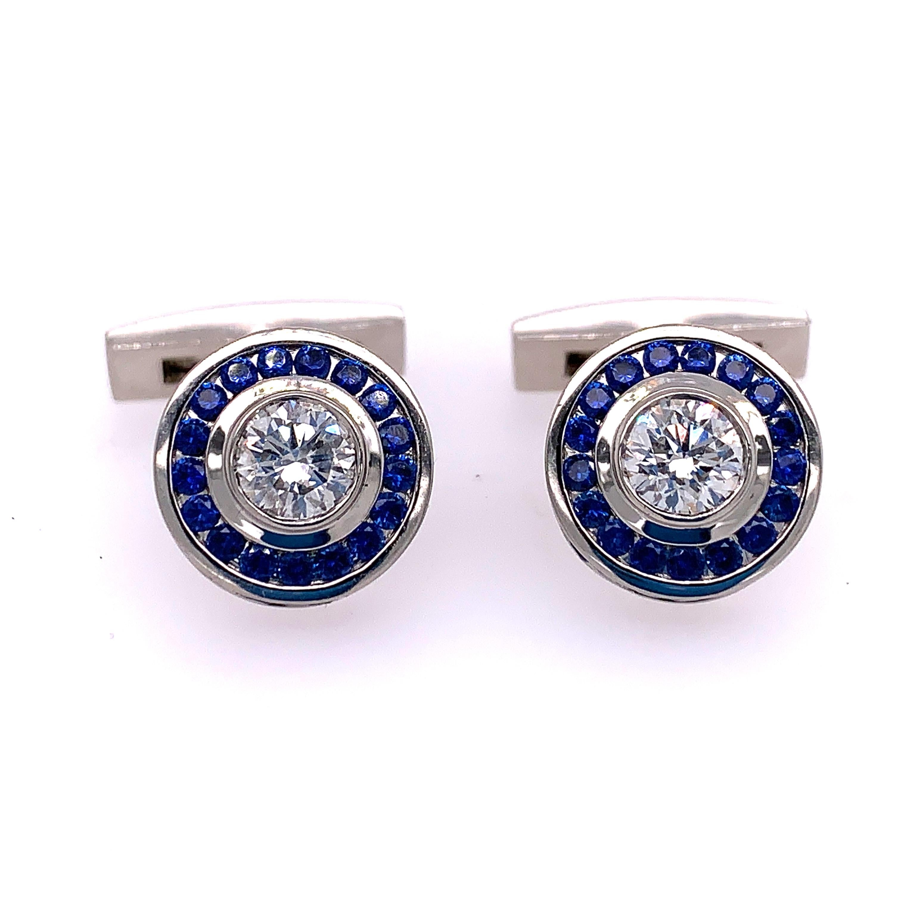 These striking cufflinks feature two GIA certified Round Brilliant cut diamonds with a G color grade and a VS1 Clarity. They weigh .72 and .71 carats each. 

Framing these center diamonds are seventy-six round Sapphires weighing a total of 1.94