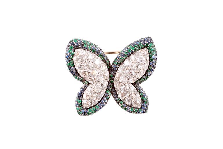 This beauty is composed of 18 karat yellow and white gold and is secured with a double pin clasp supporting European hallmarks.  The stated weights are as follows:
Diamonds:  6.94 cts
Blue Sapphires:  1.55 cts
Emeralds:  0.97 cts
When this stunner