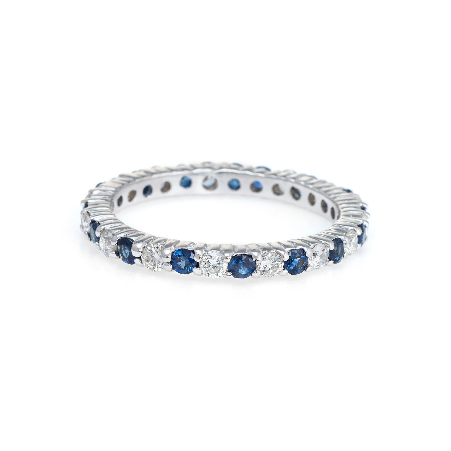 Finely detailed estate diamond & sapphire eternity ring, crafted in 14 karat white gold. 

15 round brilliant cut diamonds are estimated at 0.03 carats each and total an estimated 0.45 carats (estimated at H-I color and VS2-SI1 clarity. The 16 blue