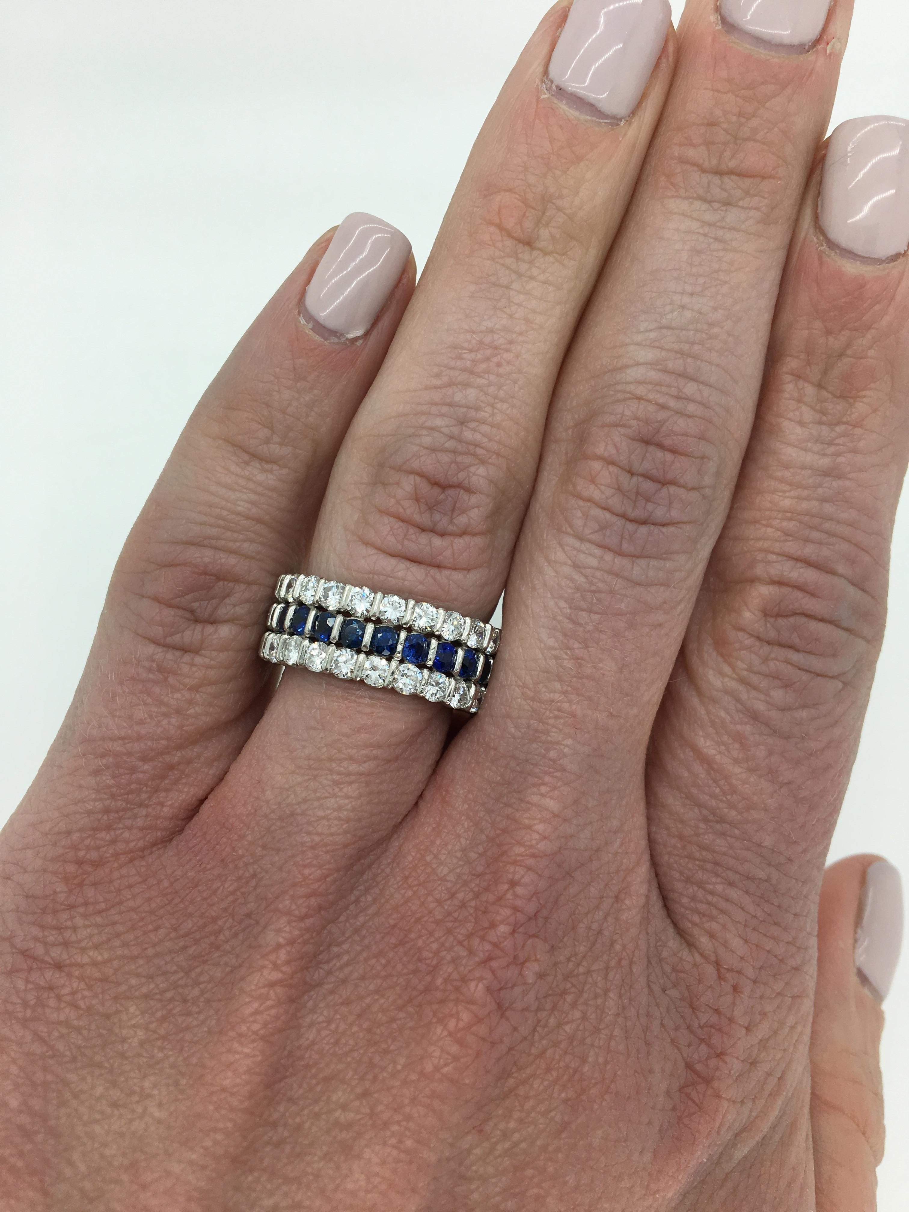 Three row eternity style diamond and blue sapphire ring crafted in platinum.

Gemstone: Diamond & Sapphire
Gemstone Carat Weight: Approximately 1.40CTW Round Cut Sapphires
Diamond Carat Weight:  Approximately 2.00CTW
Diamond Cut: Round