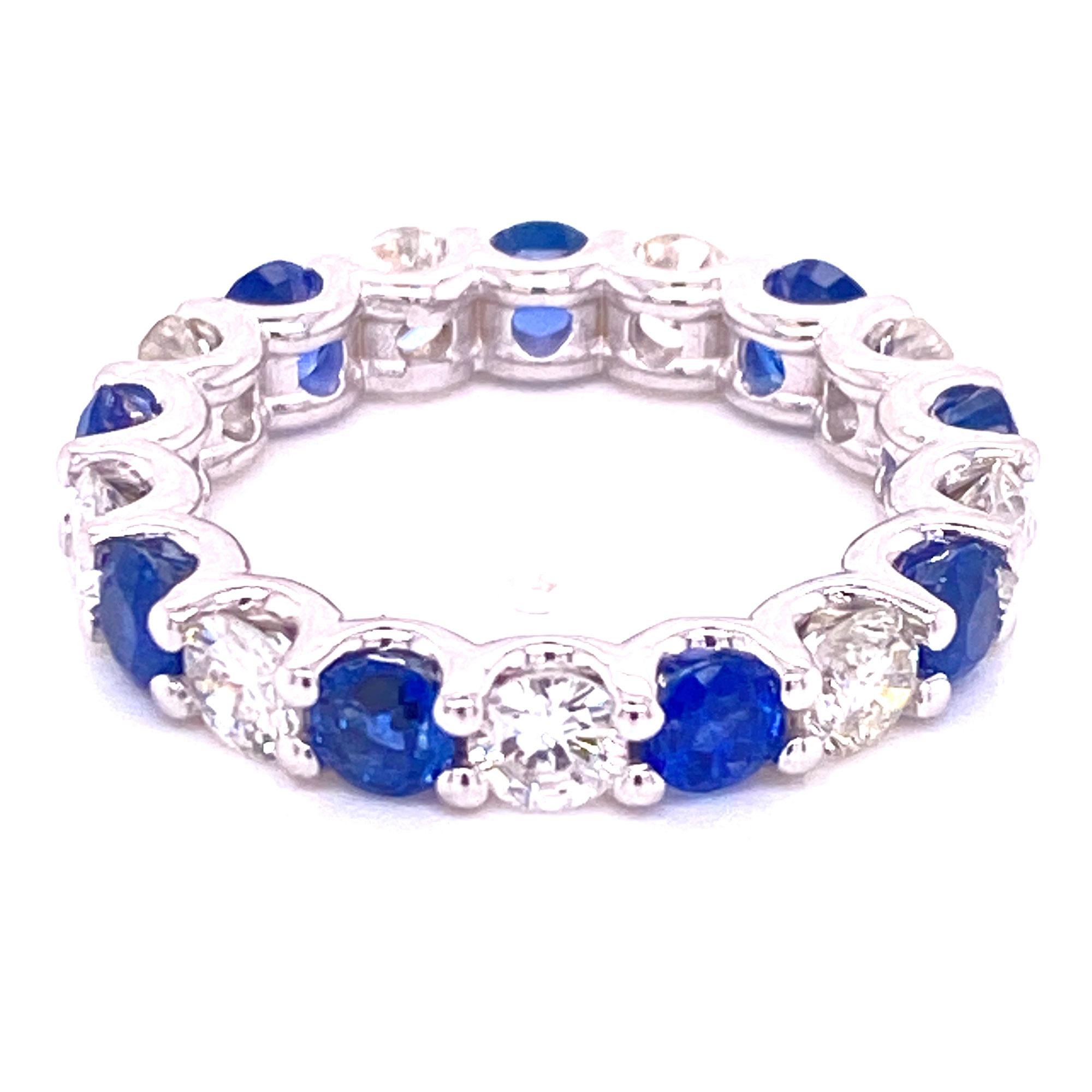 Beautiful round brilliant cut diamond and blue sapphire eternity band fashioned in 18 karat white gold U shape mounting. The band is size 6.5 and features 9 round brilliant cut diamonds (1.80 carat total weight), and 9 blue round sapphires (2.40