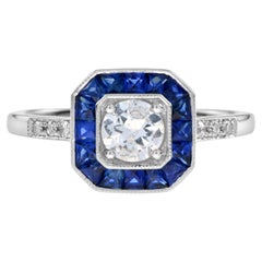 Anillo de compromiso de oro blanco con diamante y zafiro azul talla fantasía halo estilo art déco