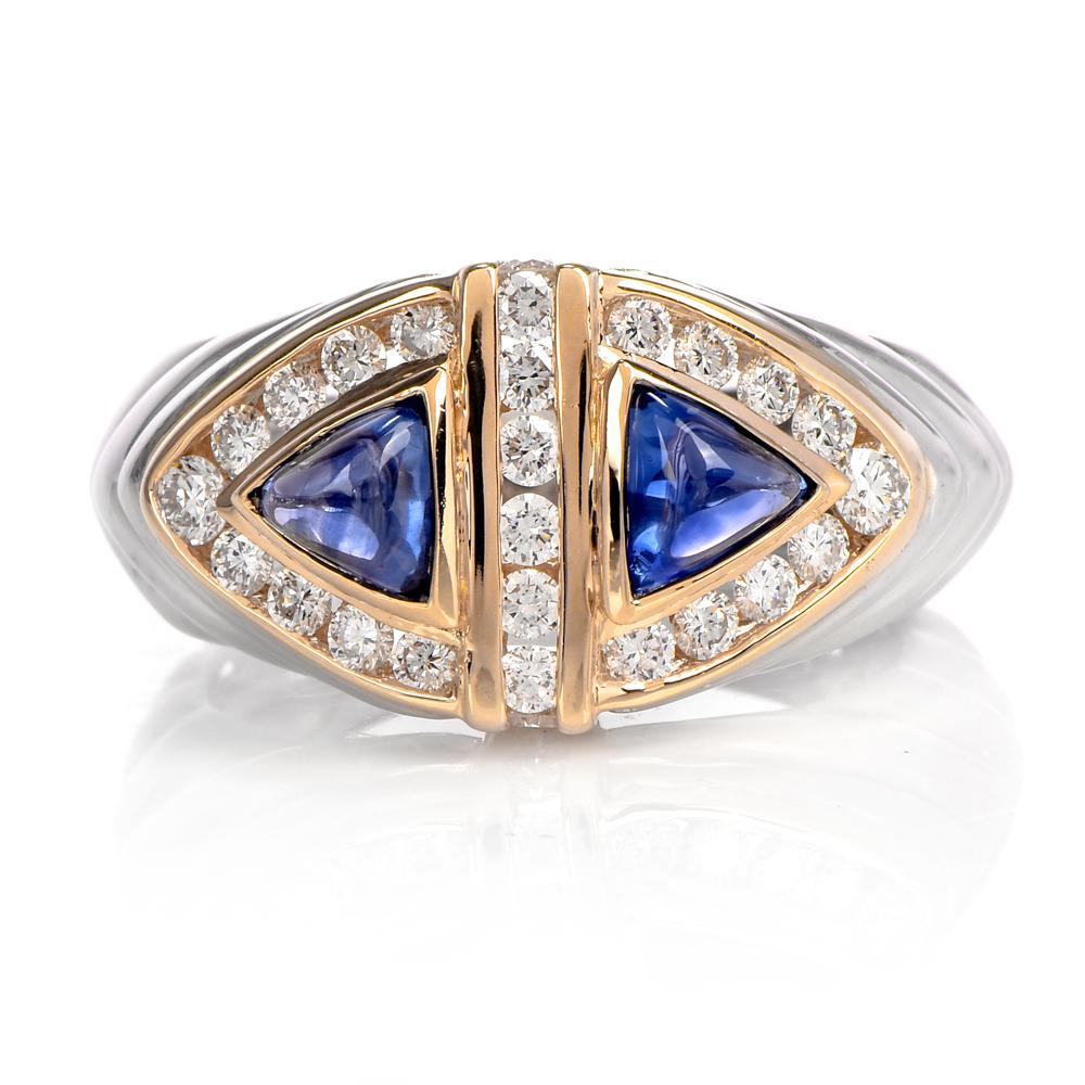This geometric unisex diamond and blue sapphire ring is crafted in a combination of platinum and 18-karat yellow gold. Composed of two bezel-set trilliant shaped blue sapphires weighing approx. 1.08 carats. Surrounded by round-cut channel set