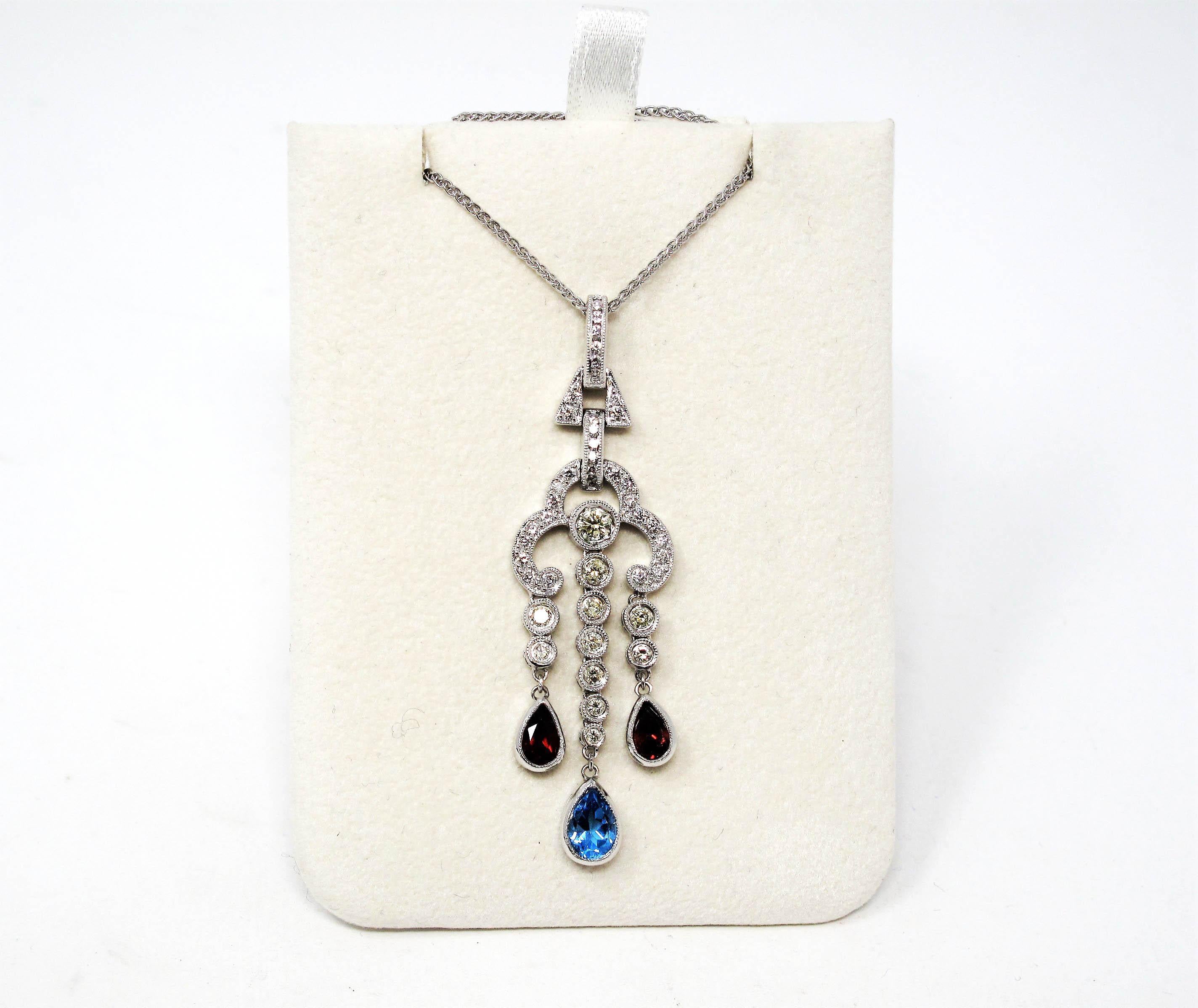 Exquisite vintage style chandelier pendant necklace featuring natural diamonds, blue topaz and Pyrope garnets. This stunningly sparkly piece glitters from every direction while the multi-colored gemstones add a colorful focal point. The dangling
