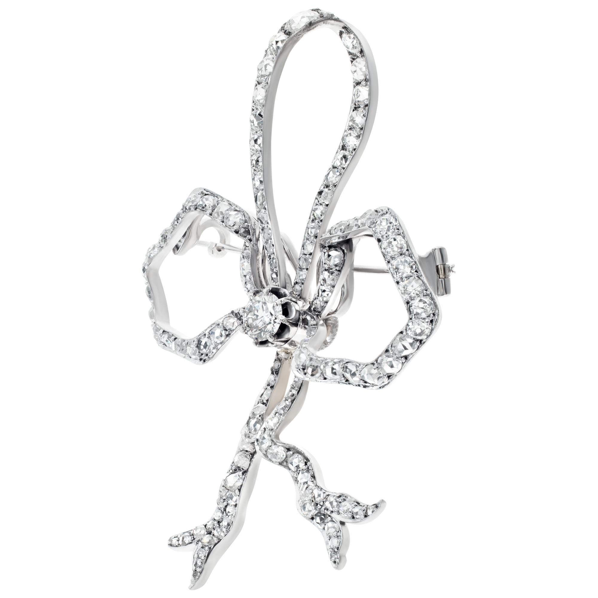 Diamond bow brooch in 18k white gold with a 1 carat center rose cut diamond and 3 carats of accent diamonds. Measurements: 1.5