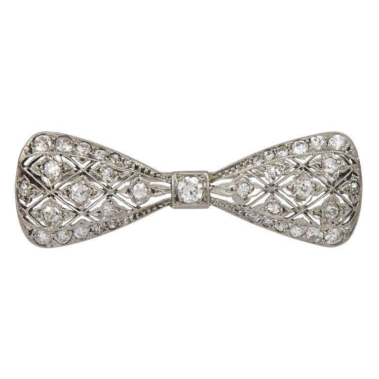 Platinum delicate Bow brooch, very fine pierced work, all over set with full-cut diamonds. Very feminine, a beautiful period piece.