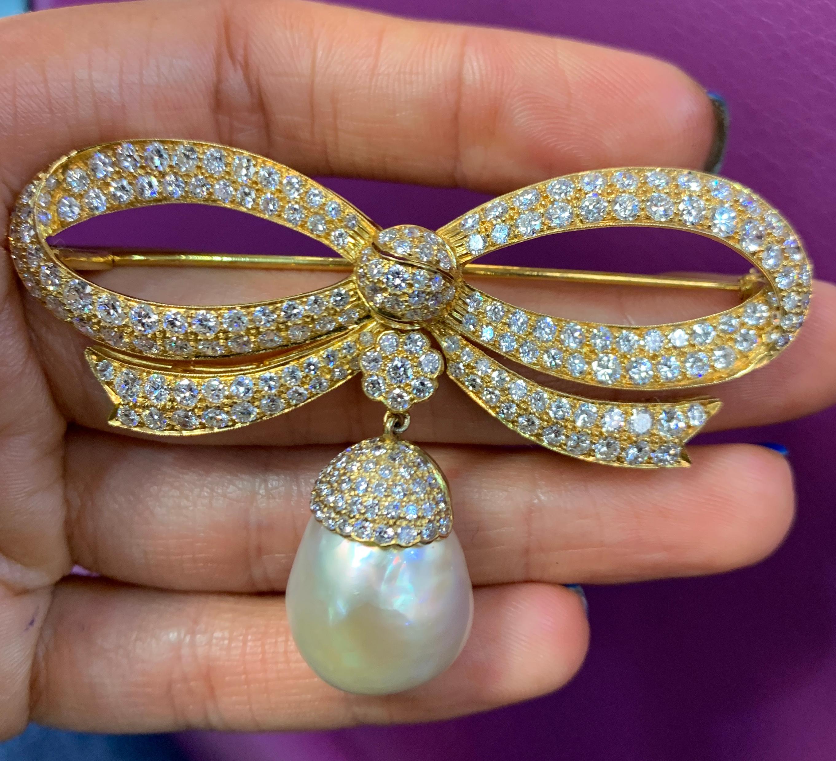 Pave Diamond Bow & Pearl Brooch
Diamond Weight: Approximately 5.50 Cts 
Set with one cultured pearl
14 karat gold 
Measurements: 2.5