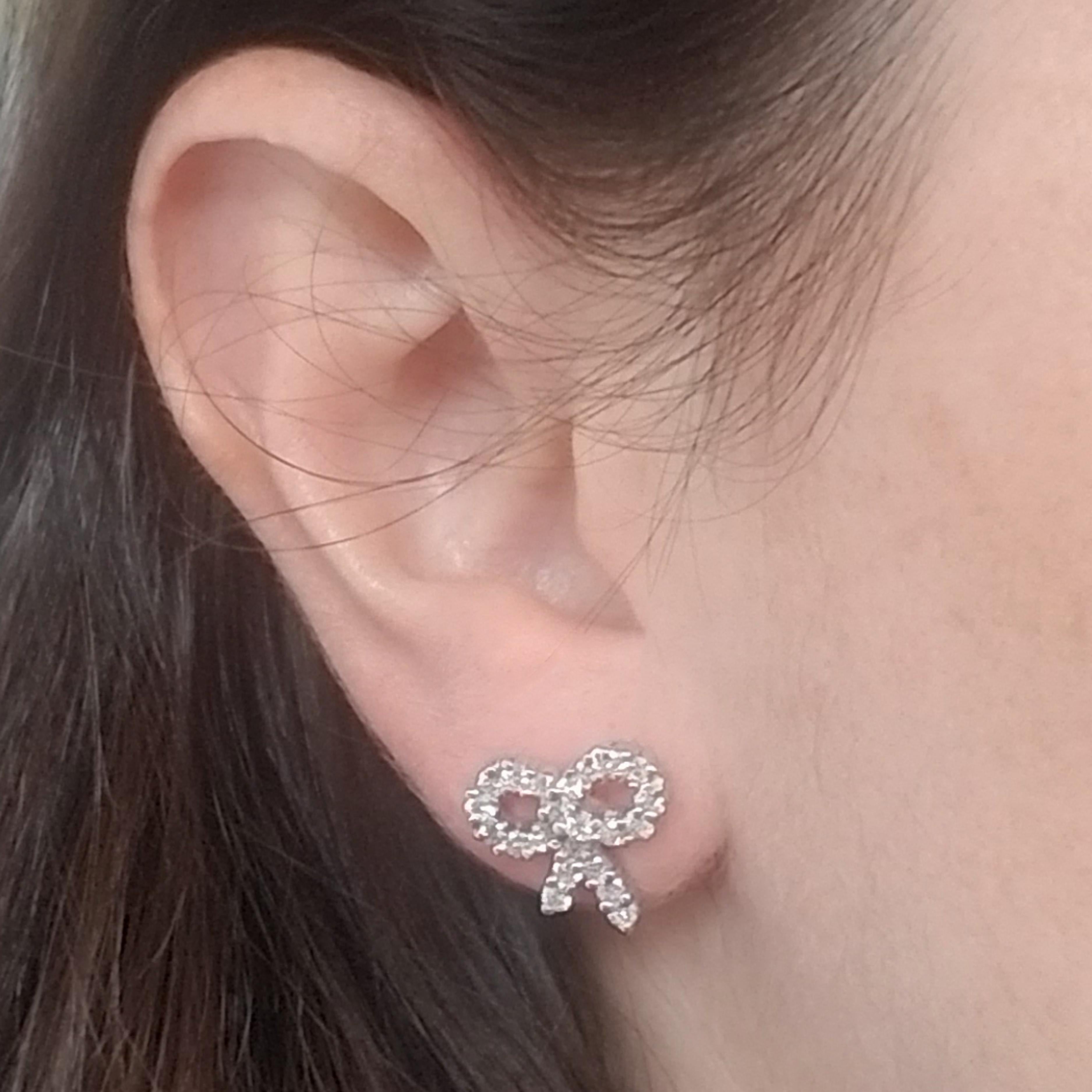 18 Karat White Gold Bow Earrings Featuring 46 Round Brilliant Cut Diamonds That Total Exactly 1.20 Carats of VS Clarity & G Color. Friction Posts With Friction Backs.