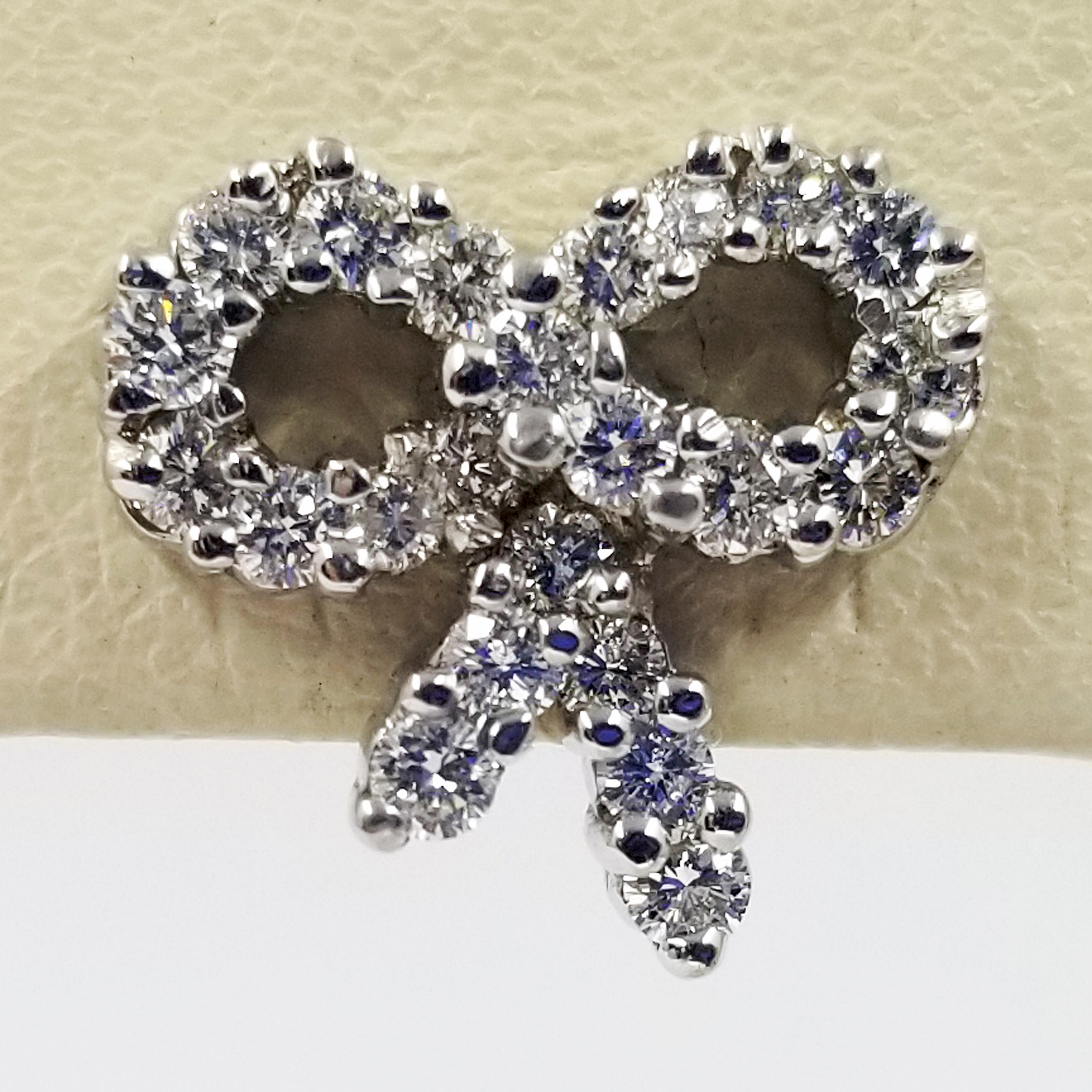 Round Cut Diamond Bow Stud Earrings in 18 Karat White Gold