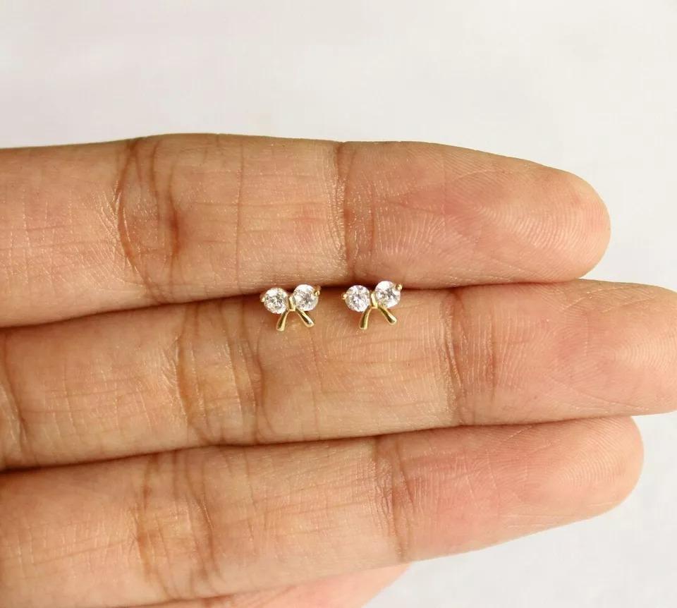 Diamond Bow Studs 14k Solid Gold Bow Tie Nose Ear Piercing Birthday Gift Charm
Light weight can be worn everyday

Additional information:
Base Metal: Yellow Gold
Main Stone Shape: Round
Material: Natural Diamond, 14k Solid Gold, Gemstone
Color: