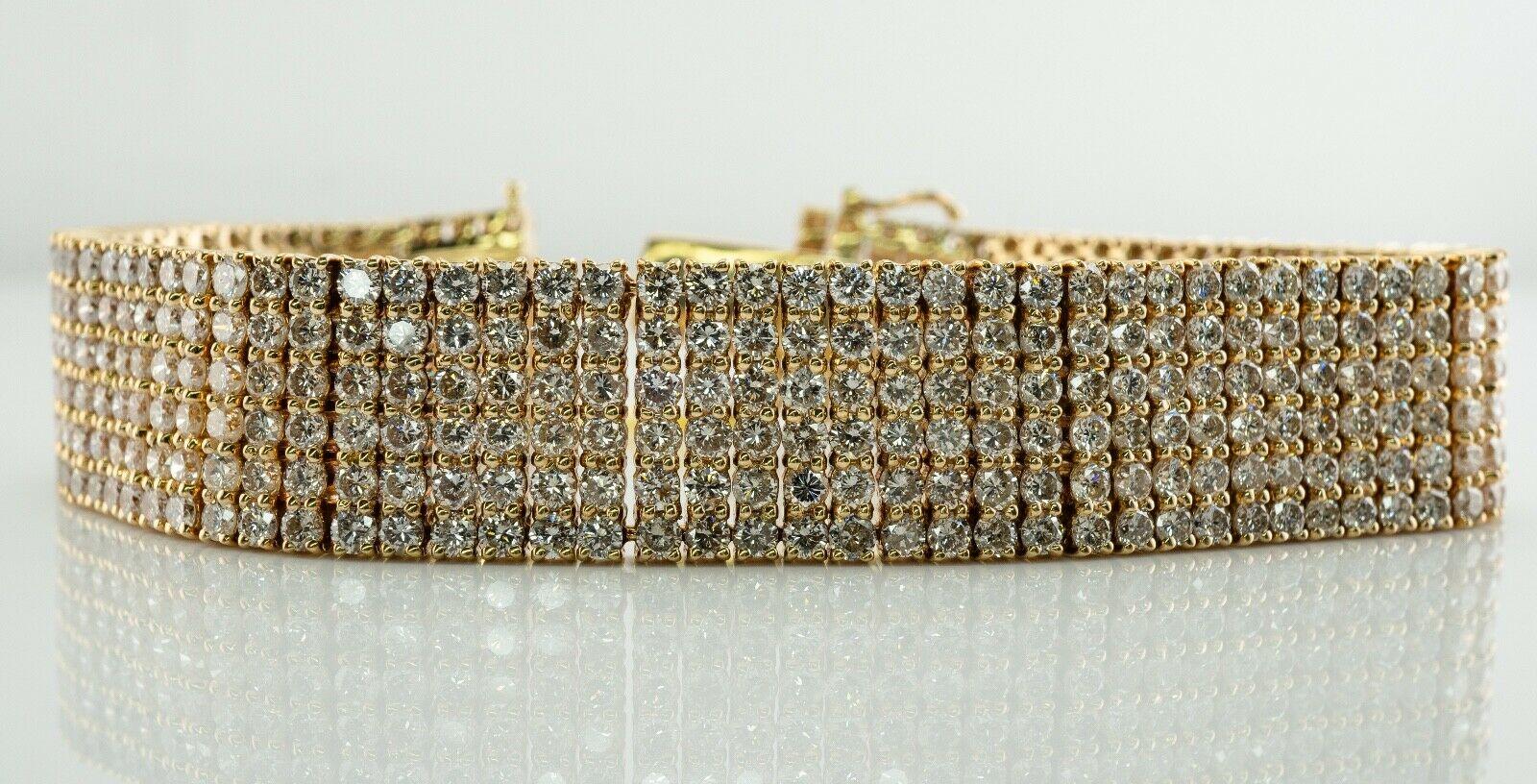This gorgeous estate bracelet still has a tag from the auction attached.
It is finely crafted in solid 18K Yellow Gold and set with 456 round brilliant cut diamonds in six rows. 
The diamonds range from VS2 to SI1 clarity and H color totaling 22.13