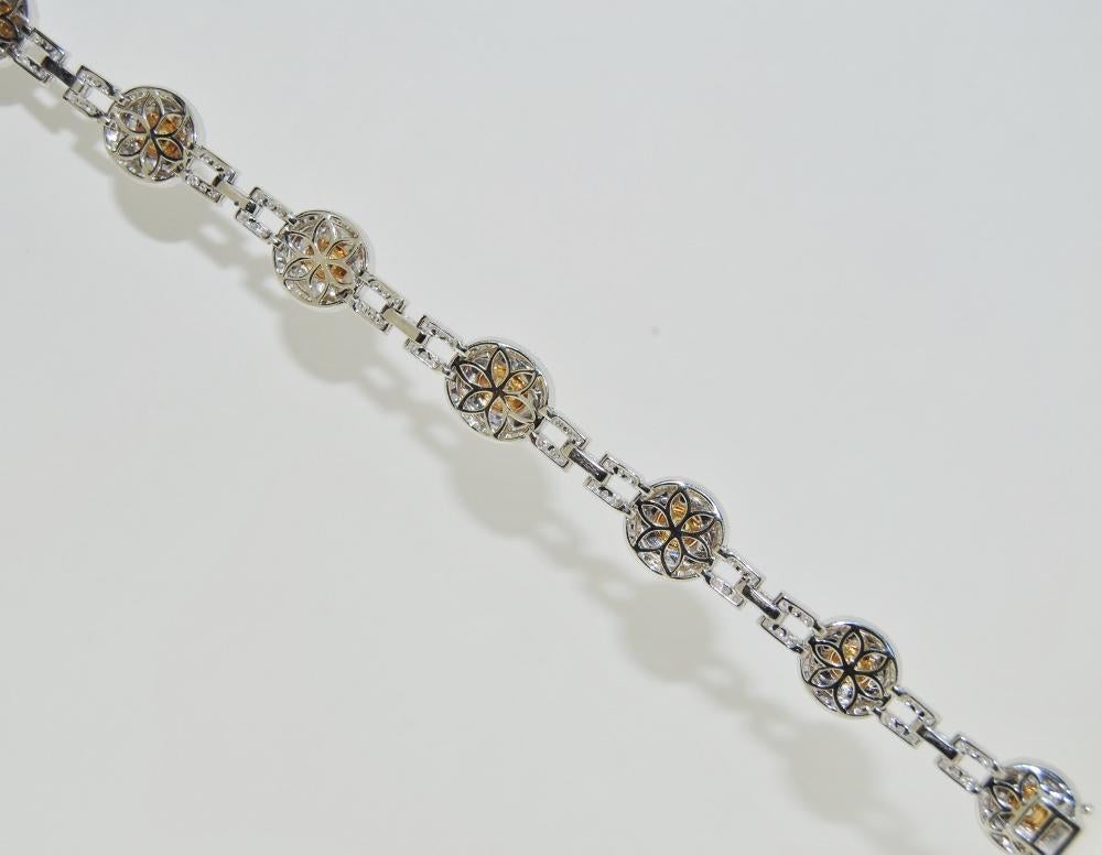 Ladies Bracelet with 3.93 Carat Round Center Yellow Diamonds, surrounded by 3.49 Carat Round White Diamonds.  This new bracelet is made of 18 Karat White Gold, length size 7 inches.