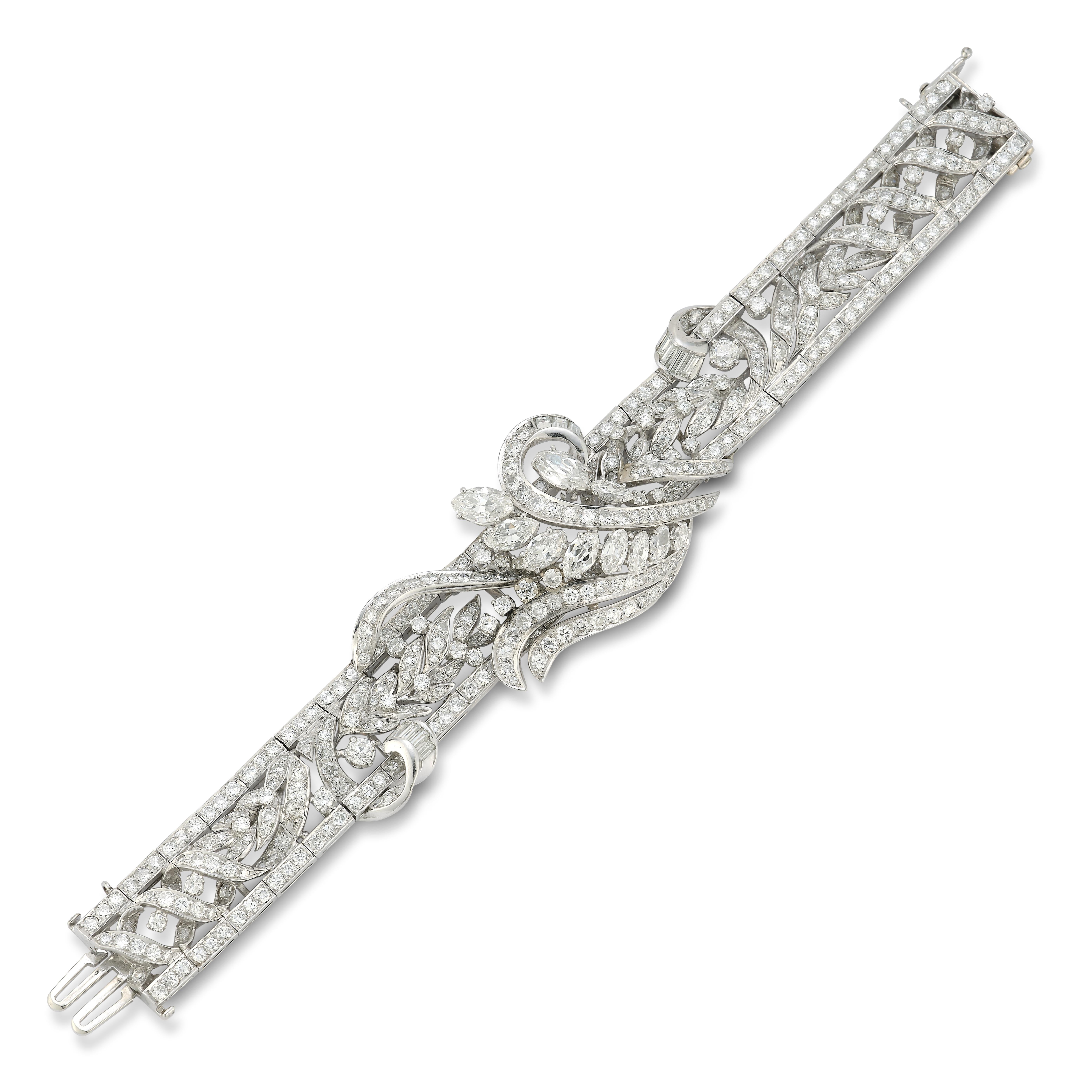 Diamond Bracelet

Set with 10 marquise, 11 baguette and 393 round cut diamonds forming a flower motif set in platinum.

Approximate Diamond Weight: 15 carats

Measurements: 6.25
