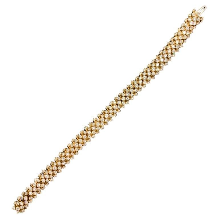 Diamond Bracelet

An 18 karat yellow gold bracelet set with 225 round cut diamonds weighing approximately 11.03 carats

Length: 7