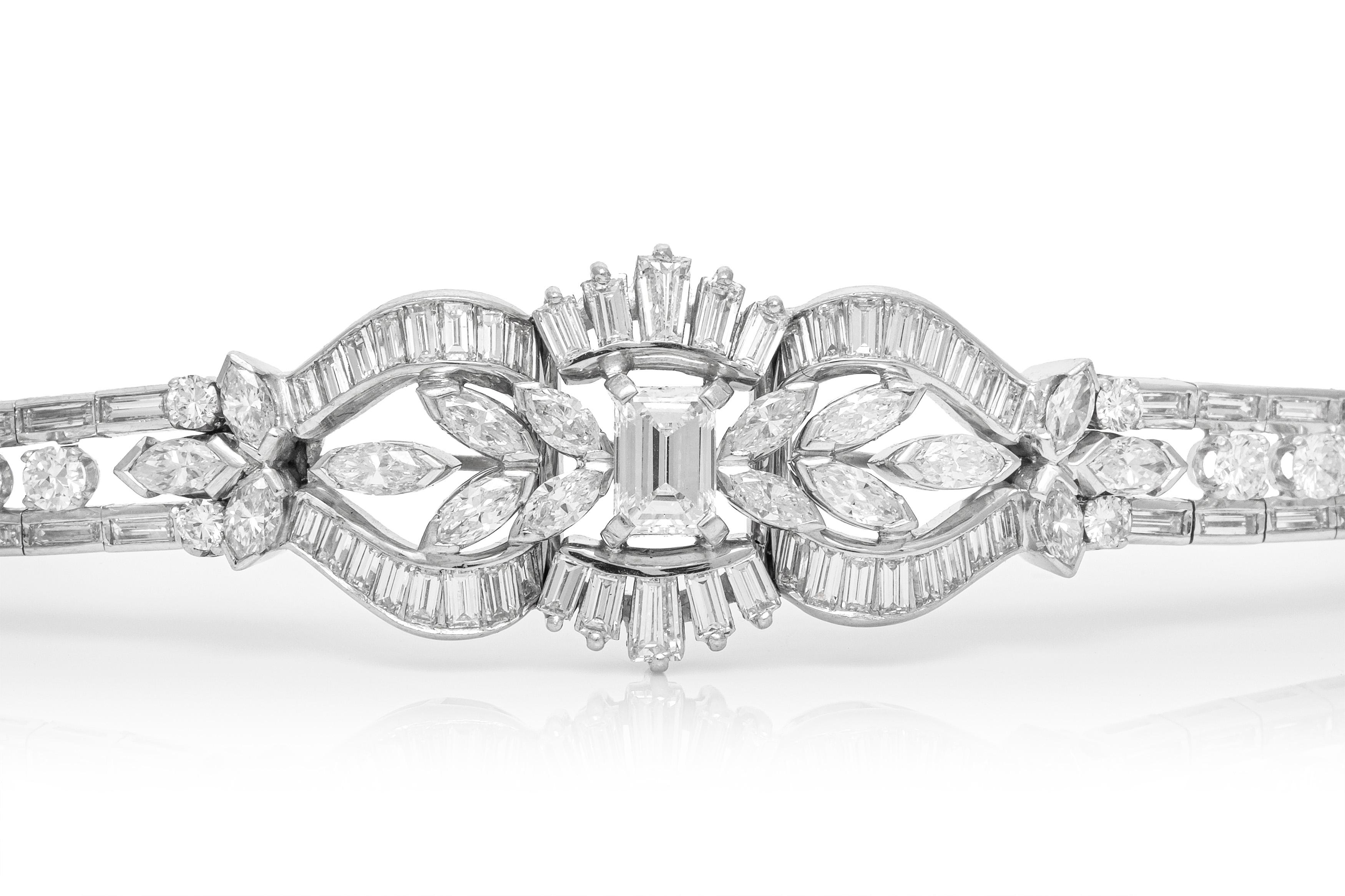 Bracelet, finely crafted in platinum with an emerald cut diamond center stone weighing approximately a total of 1.50 carat and additional diamonds weighing approximately a total of 12.00 carat. Circa 1950's.