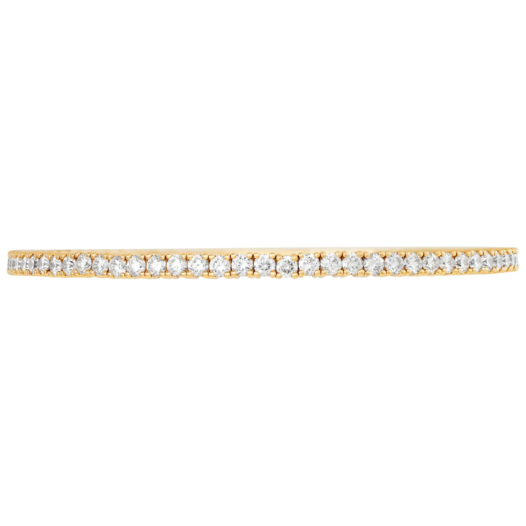 Flexible diamond line bangle bracelet in 14k yellow gold with approximately 3.95 carats in round diamonds (H-I color, SI clarity). 2.4mm width. Size 7.