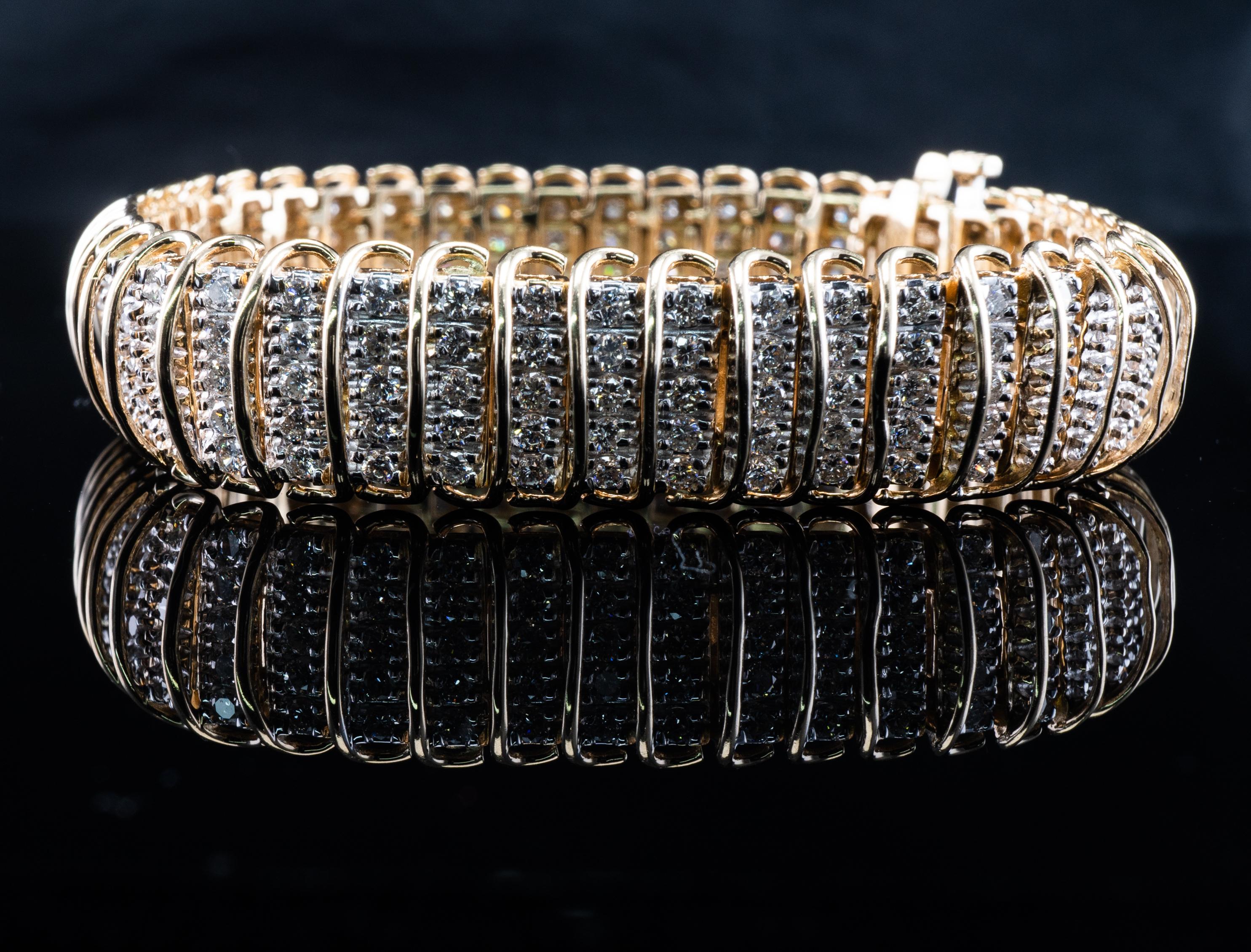 This gorgeous estate bracelet is crafted in solid 14K Yellow Gold and set with white and fiery diamonds. 
There are 230 natural round brilliant cut diamonds, 5 diamonds in each link = 16.10 cttw.
The diamonds are VVS2 clarity and H color.
The