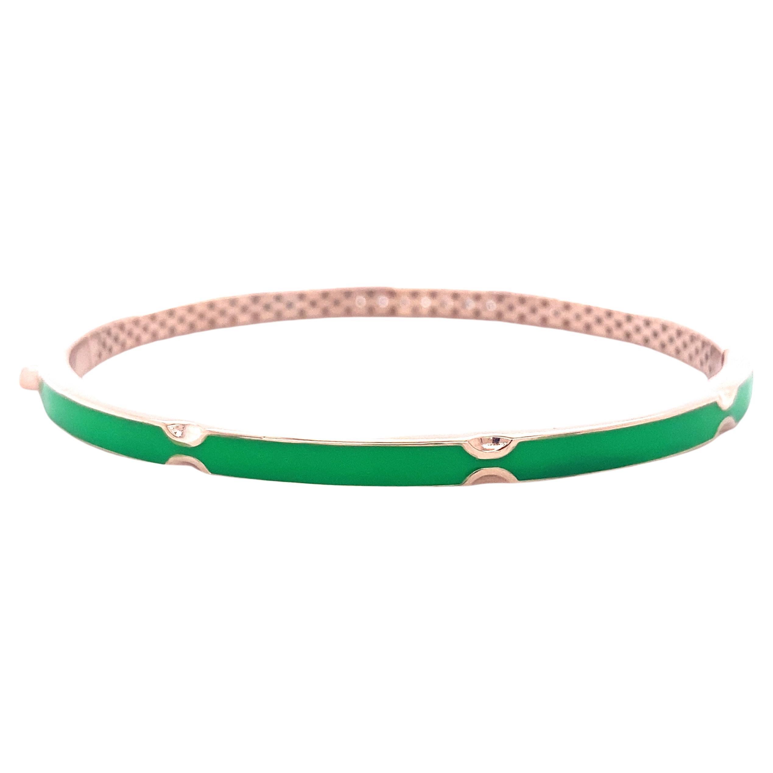 The Diamond Bracelet with Green Enamelling set in 18k Solid Gold is a stunning piece of jewelry that combines the elegance of diamonds with the vibrant beauty of green enameling. This unique bracelet features a cuff design, with one side adorned