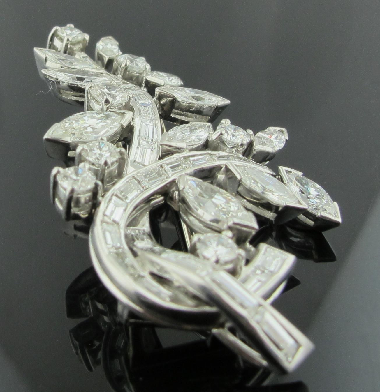 Platinum & Diamond brooch featuring round brilliant cut, marquise and baguette diamonds with a total diamond weight of approximately 7 carats. H-I color, VS