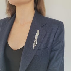 Diamond Ribbon Brooch With A Tassle Crafted In Platinum.