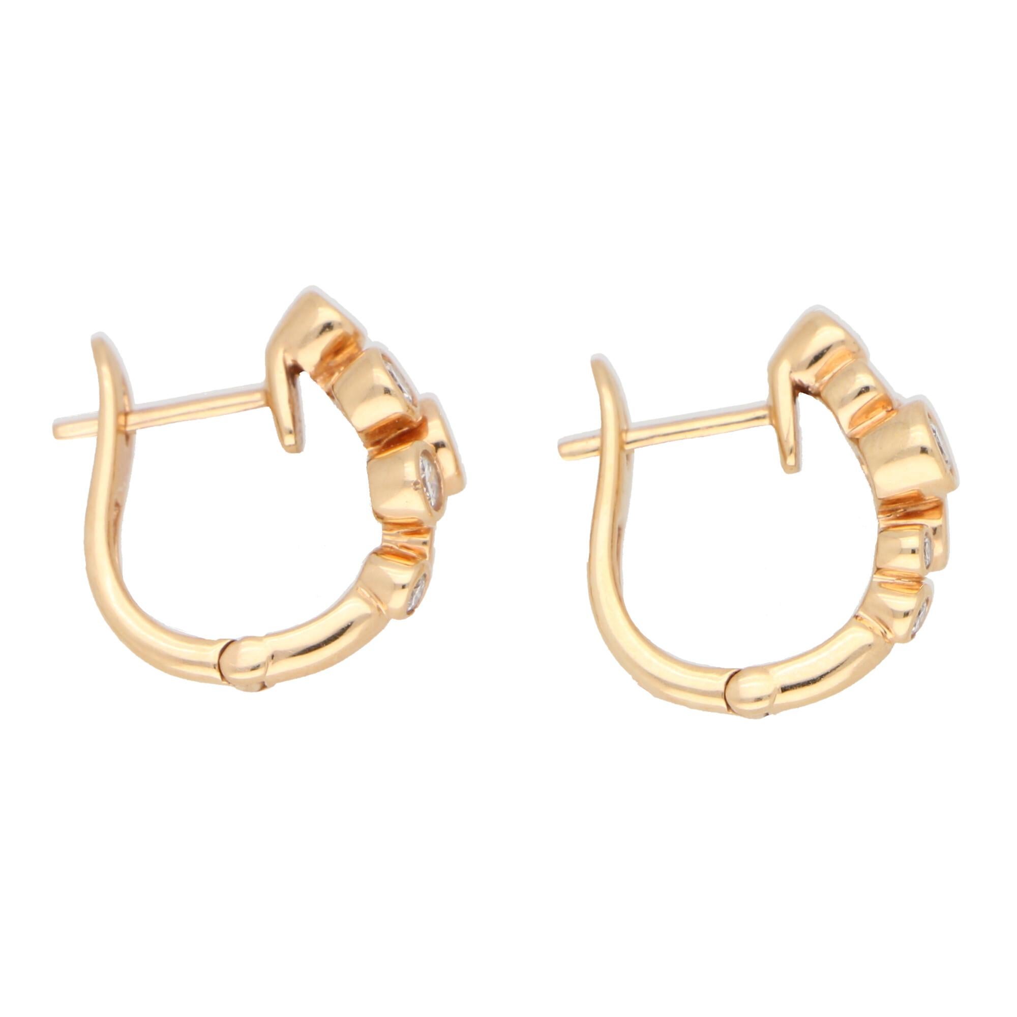 A beautiful pair of diamond huggy hoop bubble earrings set in 18k rose gold.

Each earring is set with 7 collet  set round brilliant cut diamonds of varying size which gives them a lovely spread once on the ear. The earrings themselves almost