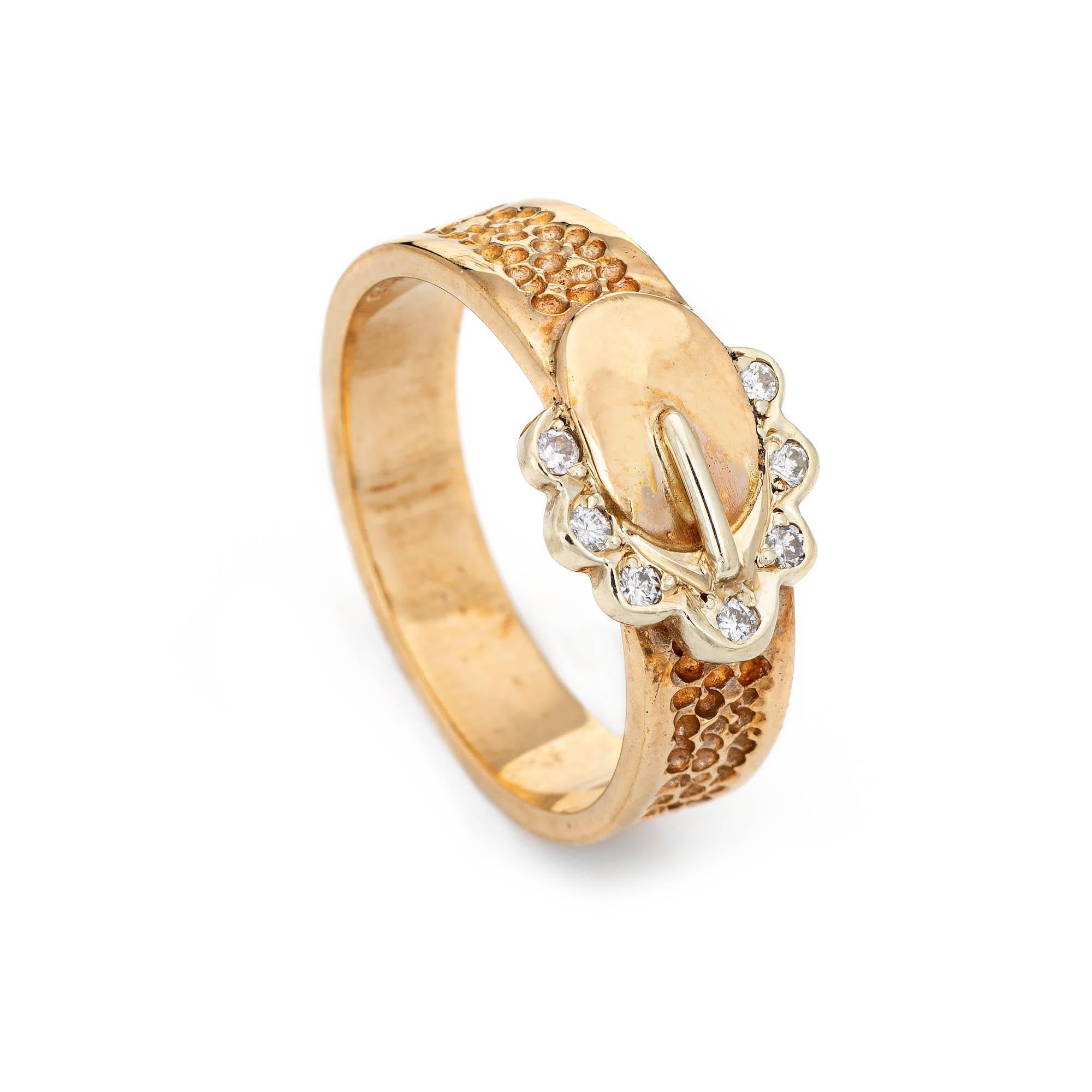 Stylish vintage diamond buckle ring crafted in in 9 karat yellow gold (circa 1960s to 1970s). 

Round brilliant cut diamonds total an estimated  0.14 carats (estimated at I-J color and SI1-2 clarity). 

The romantic buckle motif represents the