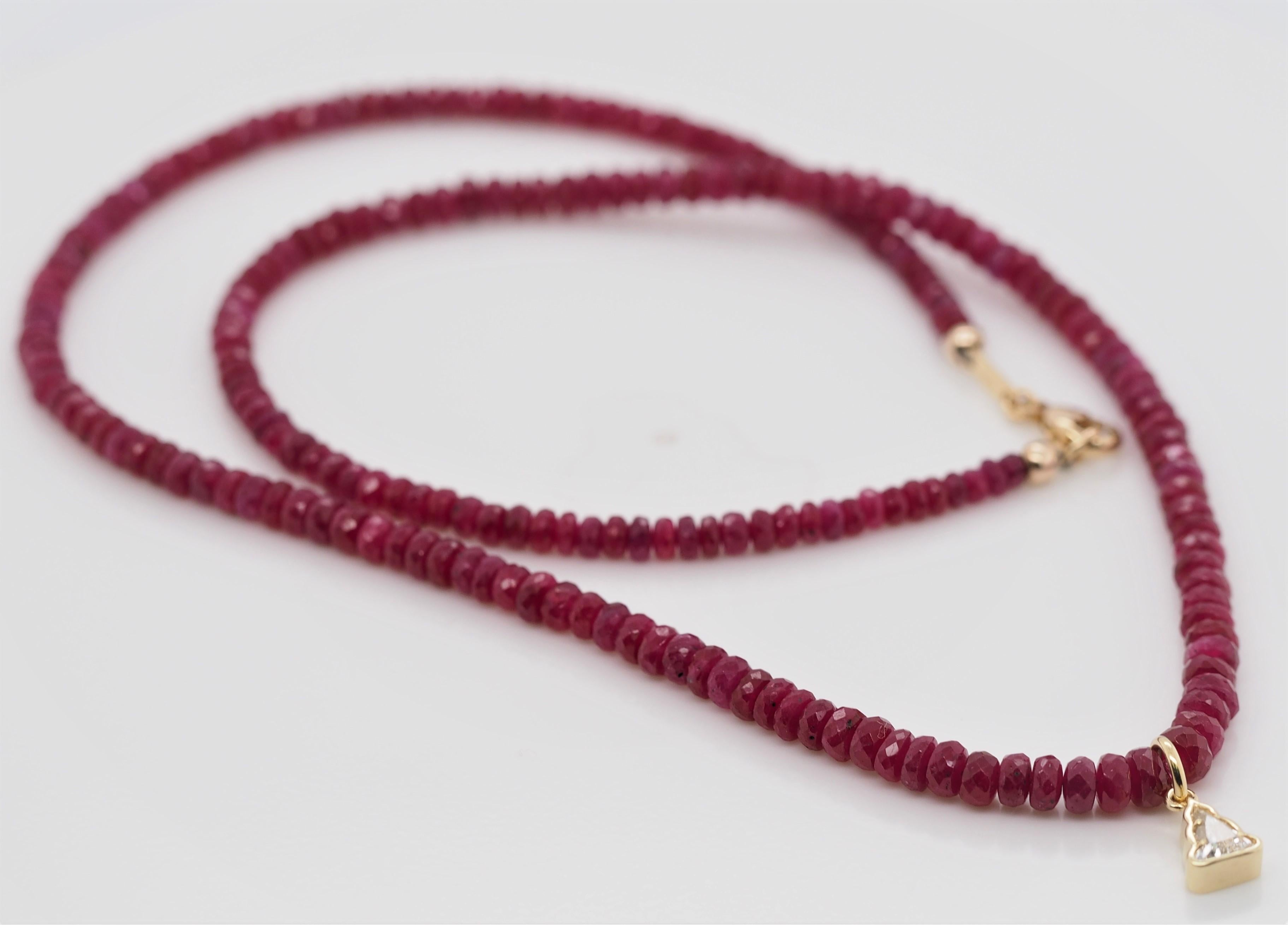 18K Yellow Gold Bezel Set 0.31 ct Diamond Buddha and Genuine Rondelle Ruby Beaded Necklace is absolutely divine. The ruby beads range in size from 3.2 mm to 4.1 mm in diameter. Every bead in the necklace is genuine ruby. The colors are very bright