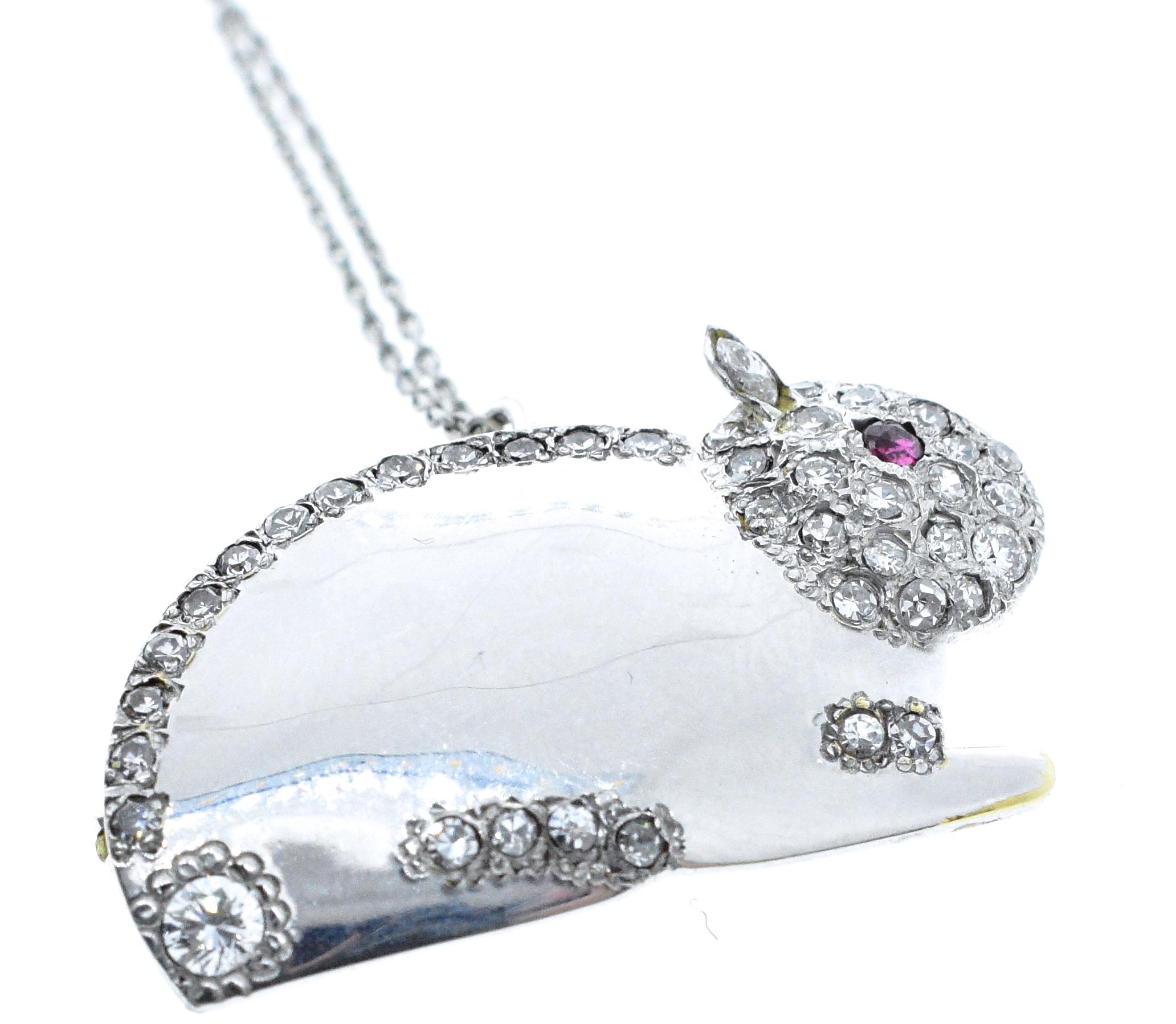 Diamonds set in 18K white gold in the motif of a bunny with a natural ruby eye. He has 40 white brilliant cut diamonds throughout his body with a total diamond weight of .75 cts. In fine condition, he is 1.5 inches in length and can be worn as a