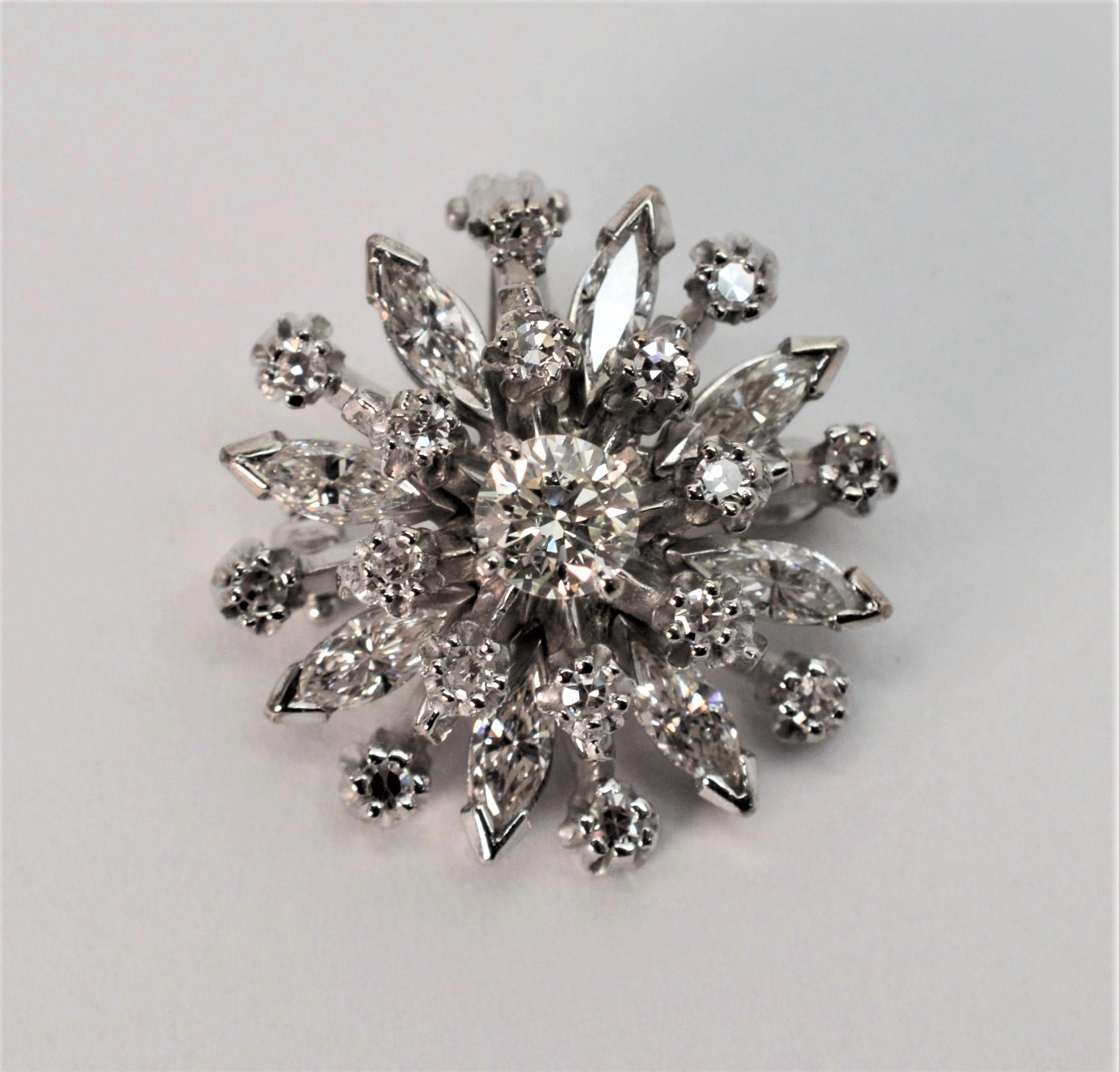 Both faceted round and marquise shaped diamonds impact the fine design of this vintage piece. Twenty four fine white H/VS diamonds with a total weight of .84 carats create the burst of sparkle on this fourteen karat 14k white gold brooch. With a