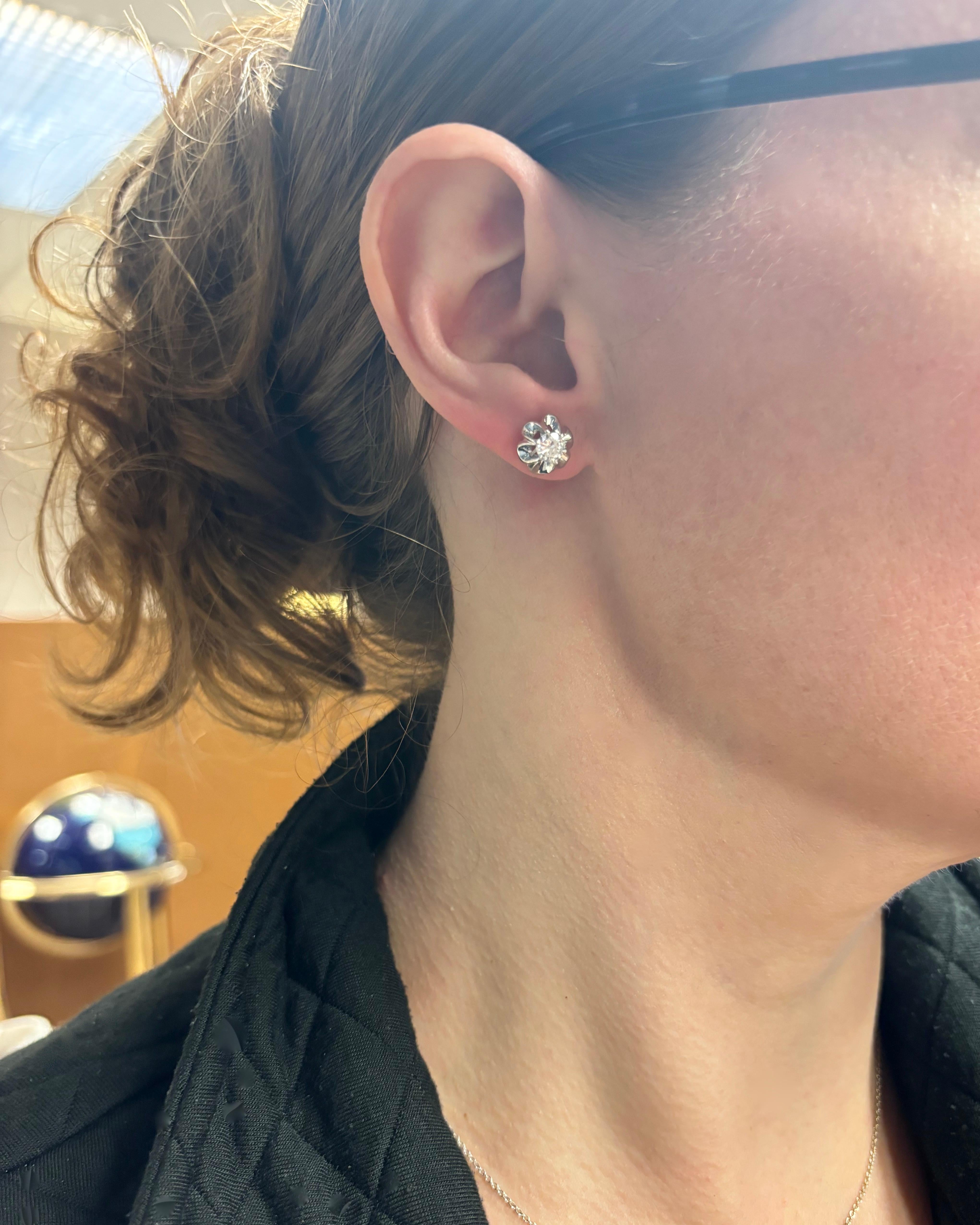 Vintage buttercup style diamond stud earrings. 

Diamond Carat Weight: .64CTW
Diamond Cut: Round Brilliant Cut 
Color: E-F
Clarity: VS1-VS2
Metal: 14k White Gold 
Weight: 4.4 Grams