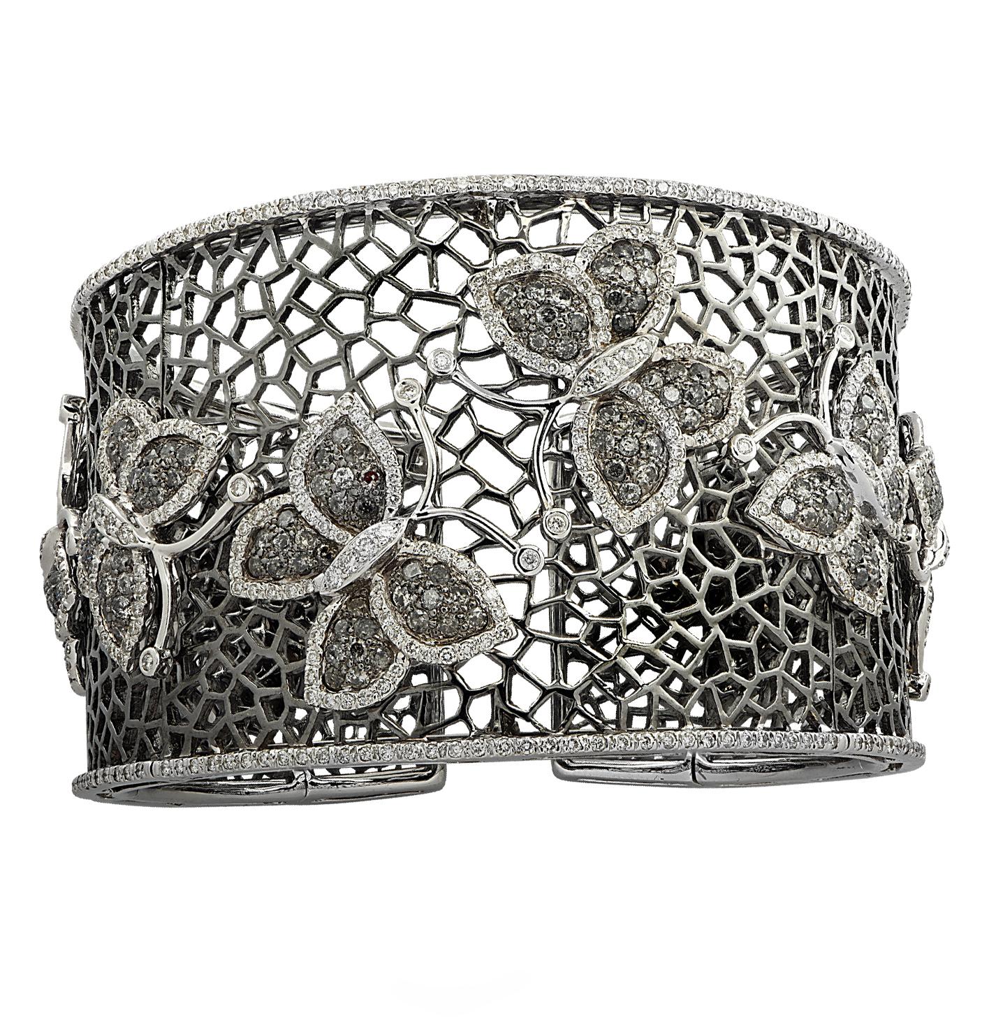 Delightful butterfly cuff bangle bracelet crafted in 18 karat white gold with black rhodium, featuring 780 round brilliant cut diamonds weighing approximately 7.66 carats total, G-H color, I clarity. Eight enchanting diamond encrusted butterflies