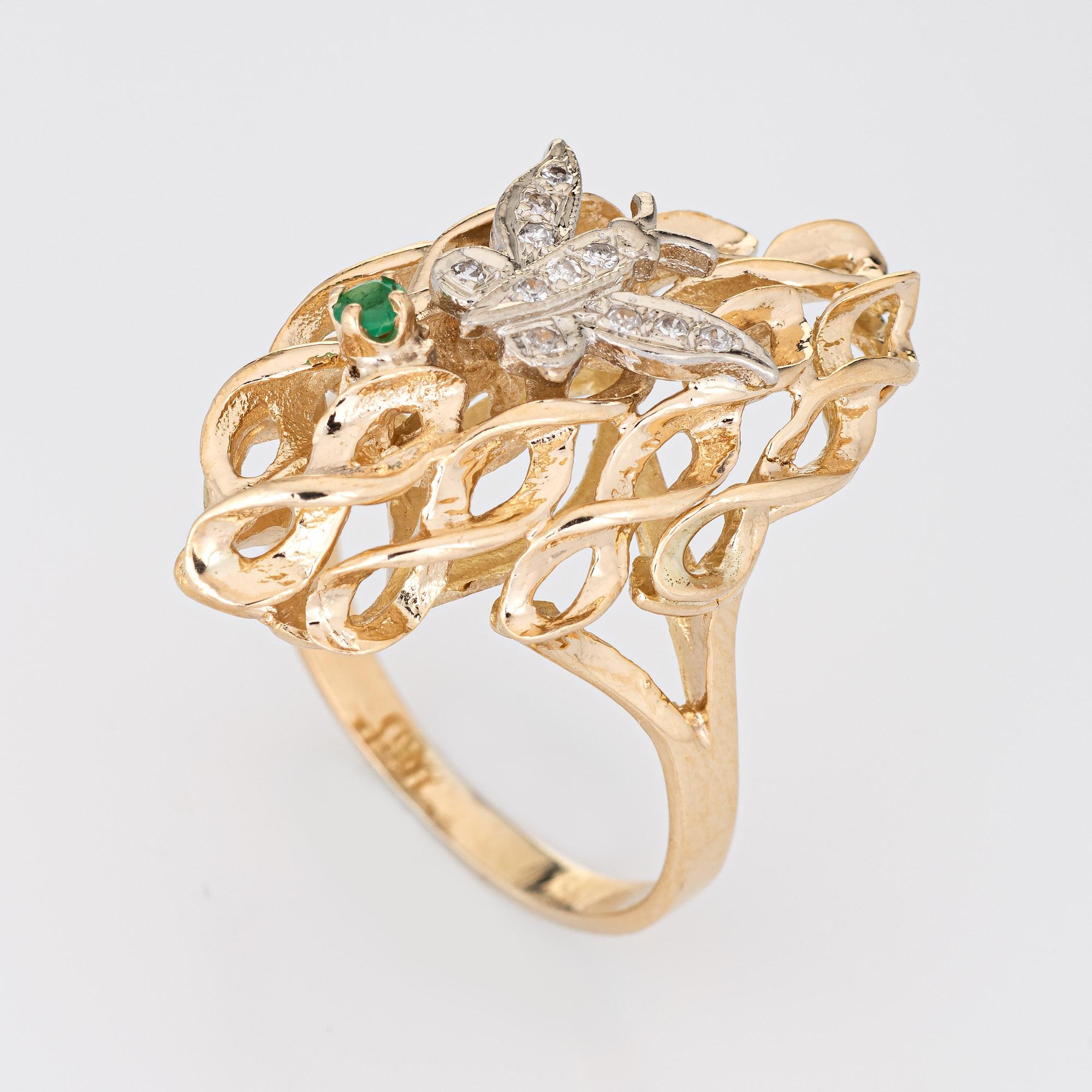 Stylish vintage diamond butterfly ring (circa 1970s to 1980s) crafted in 14 karat yellow gold. 

Diamonds total an estimated 0.05 carats (estimated at I-J color and SI2-I2 clarity), accented with one estimated 0.04 carat emerald.  

The nicely