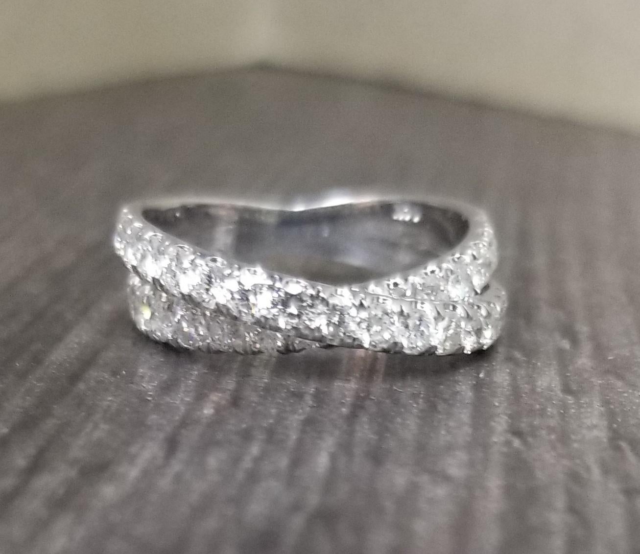 14k white gold ladies diamond by pass ring, containing 31 round full cut diamonds; color 