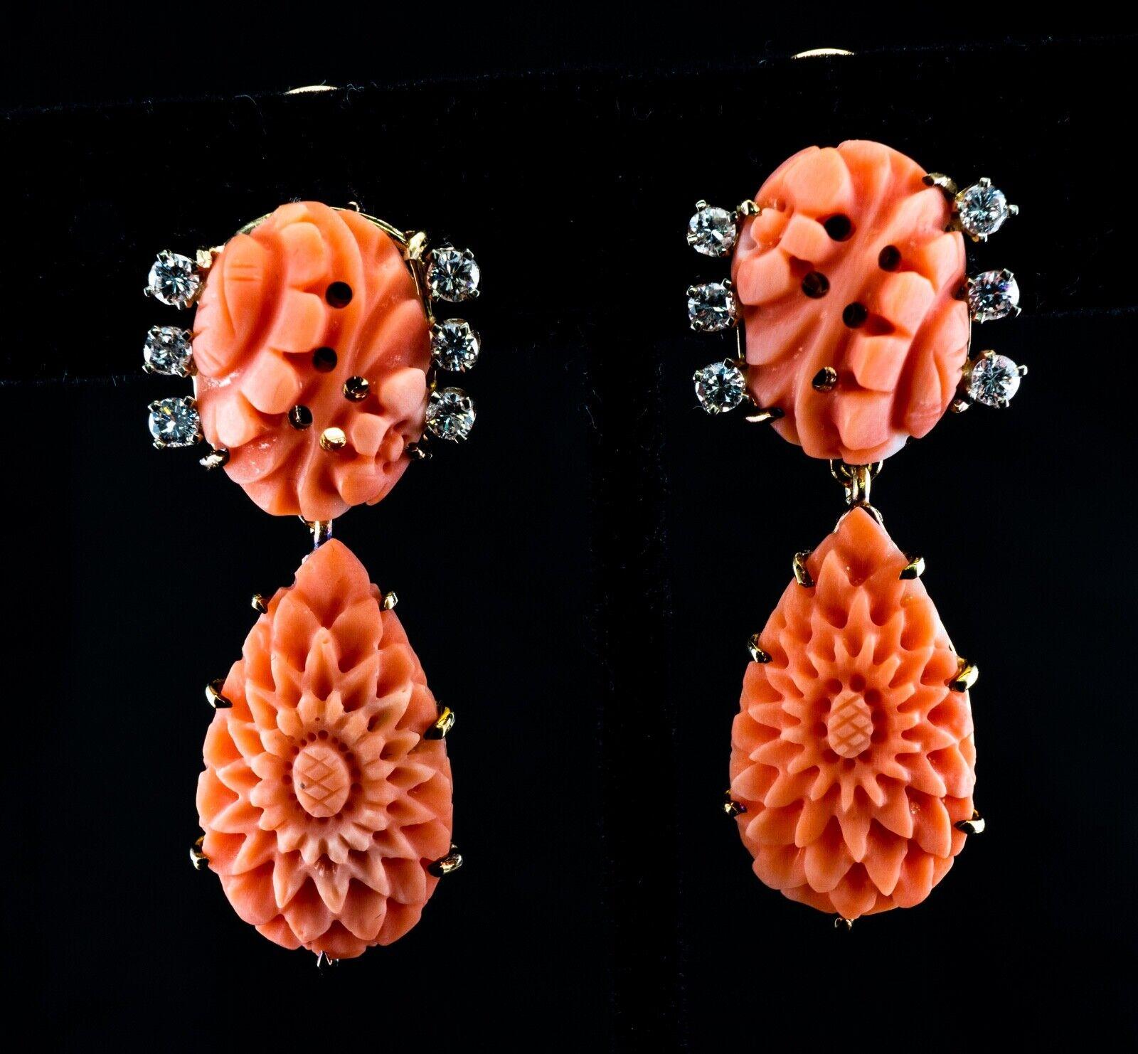 This gorgeous vintage pair of earrings is crafted in solid 14K Yellow Gold and set with genuine Salmon corals and diamonds. The carved pear shaped coral on the bottom measures 25mm. The top coral is 17mm. It is adorned with 6 round brilliant cut